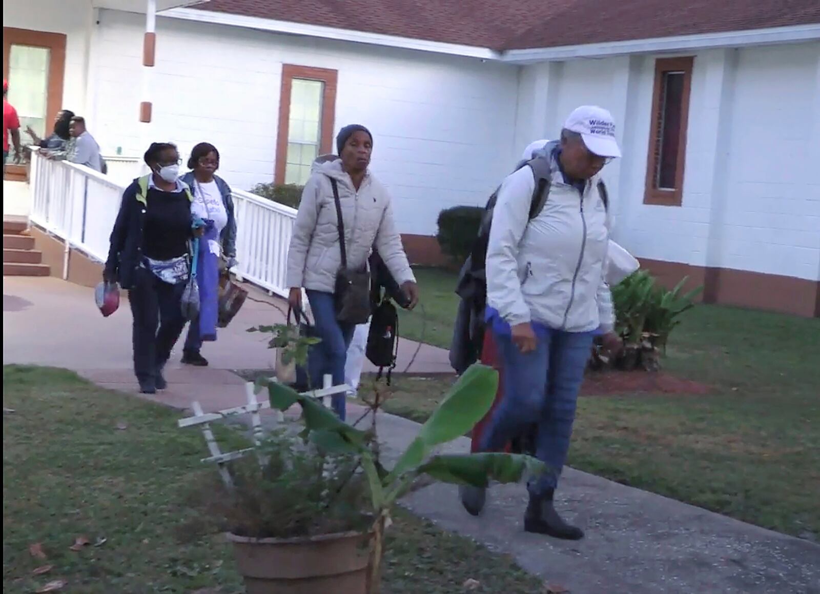 Festival goers who attended a Gullah Geechee festival on Sapelo Island leave the Elm Grove Church where they were taken to reunite with loved ones on Sapelo Island, Ga in McIntosh county, Sunday, Oct. 20, 2024. (AP Photo/Lewis M. Levine)