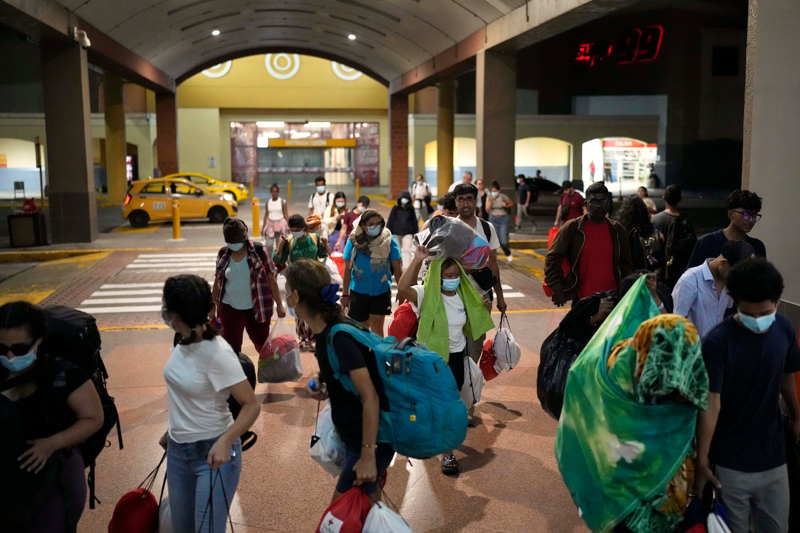 Migrants, mostly from Asian countries, arrived in Panama City on Saturday, March 8, 2025, after spending weeks in a Panamanian immigration camp following their deportation from the U.S. and being released on the condition that they leave the country within 30 days. (AP Photo/Matias Delacroix)