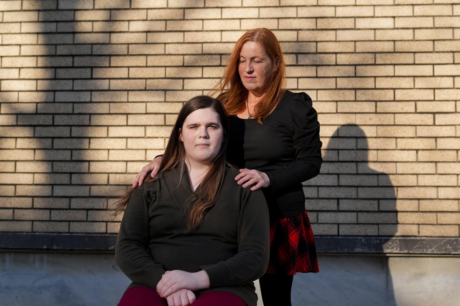 Mellow, a transgender woman, left, poses for a portrait with her mother, Lisa Suhay, Monday, Feb. 3, 2025, in Norfolk, Va. (AP Photo/Stephanie Scarbrough)