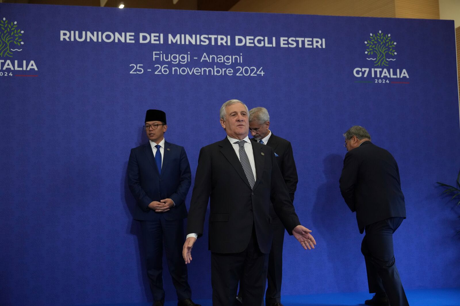 Italian Foreign Minister Antonio Tajani, center, reacts as he waits for the family photo at the G7 of foreign Ministers in Fiuggi, some 70 kilometers south-east of Rome, Tuesday, Nov. 26, 2024. (AP Photo/Alessandra Tarantino, Pool)