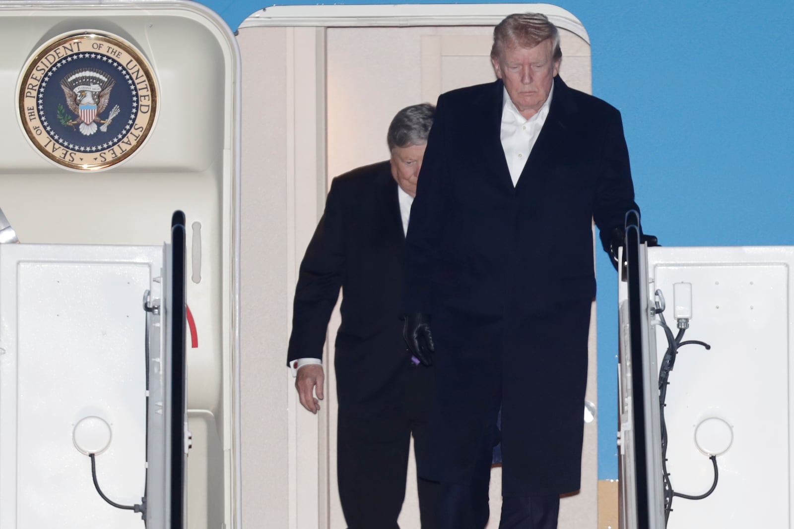 President Donald Trump walks down the stairs of Air Force One upon his arrival at Joint Base Andrews, Md., Sunday, March 2, 2025. (AP Photo/Luis M. Alvarez)