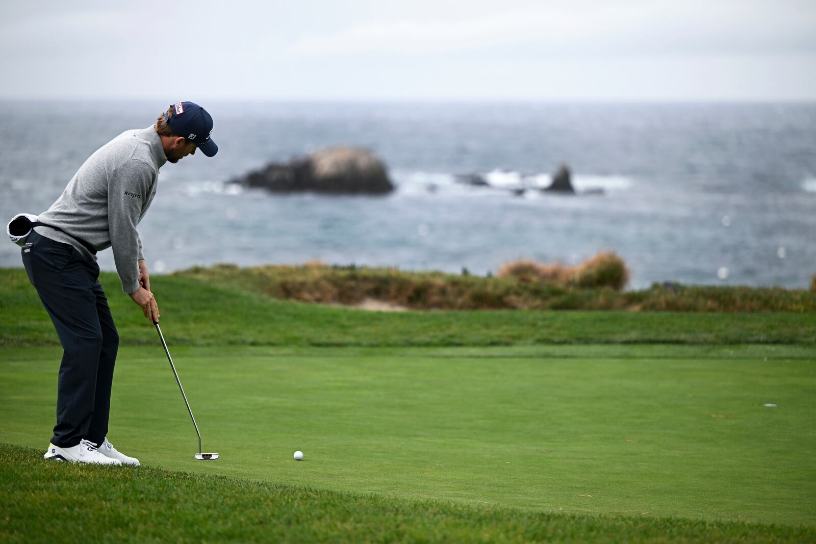 Russell Henley putts on the fourth green at Pebble Beach Golf Links during the third round of the AT&T Pebble Beach Pro-Am golf tournament, Saturday, Feb. 1, 2025, in Pebble Beach, Calif. (AP Photo/Nic Coury)