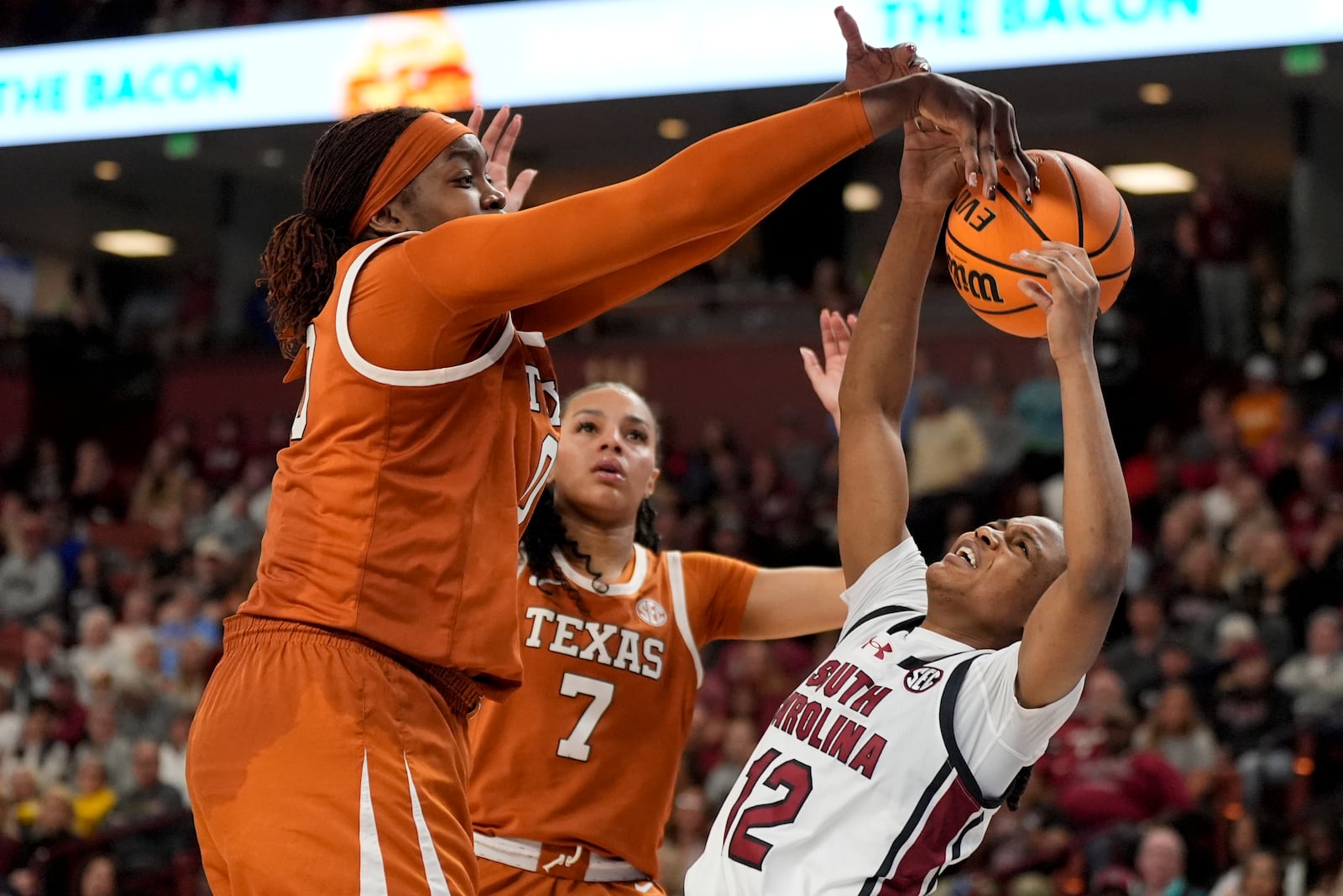 Texas forward Kyla Oldacre fouls South Carolina guard MiLaysia Fulwiley during the second half during of an NCAA college basketball game in the final of the Southeastern Conference tournament, Sunday, March 9, 2025, in Greenville, S.C. (AP Photo/Chris Carlson)