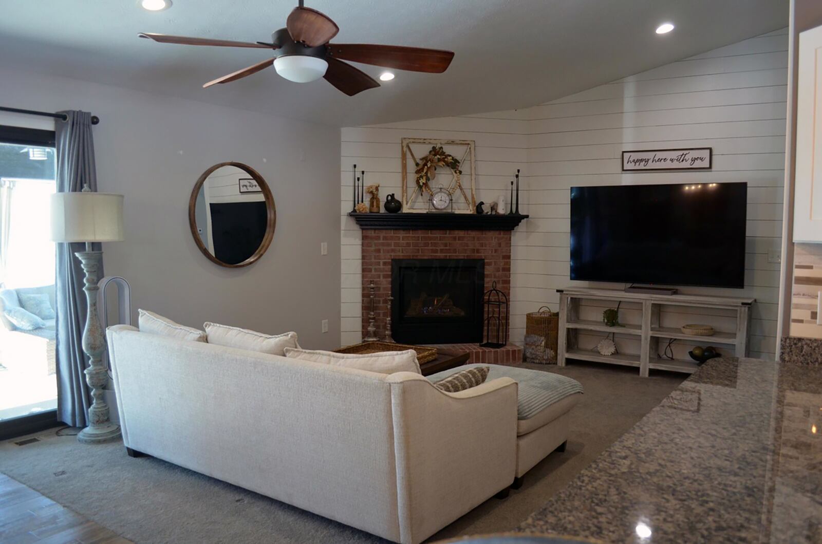 The family room has a vaulted ceiling, ceiling fan and recessed lighting and a gas fireplace.