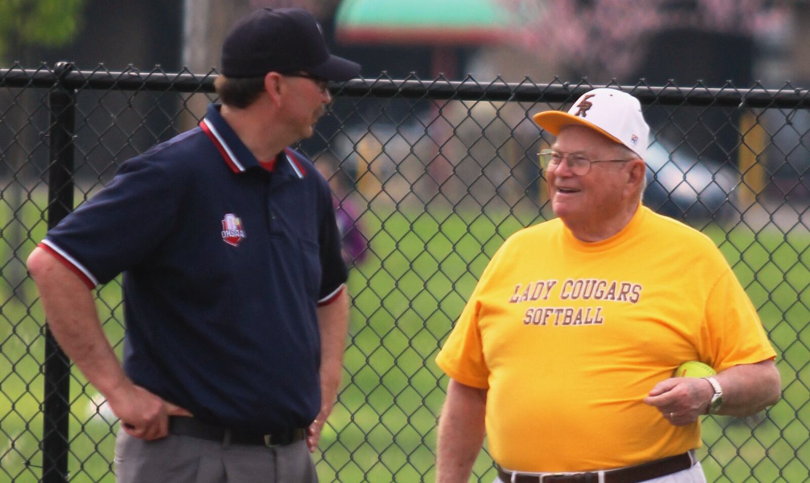 Veteran Kenton Ridge assistant Emil Leach (right) talks with an official between innings in 2015 at Stebbins. Kenton Ridge's victory gave Leach his 1,000th career victory combined from girls basketball and softball.