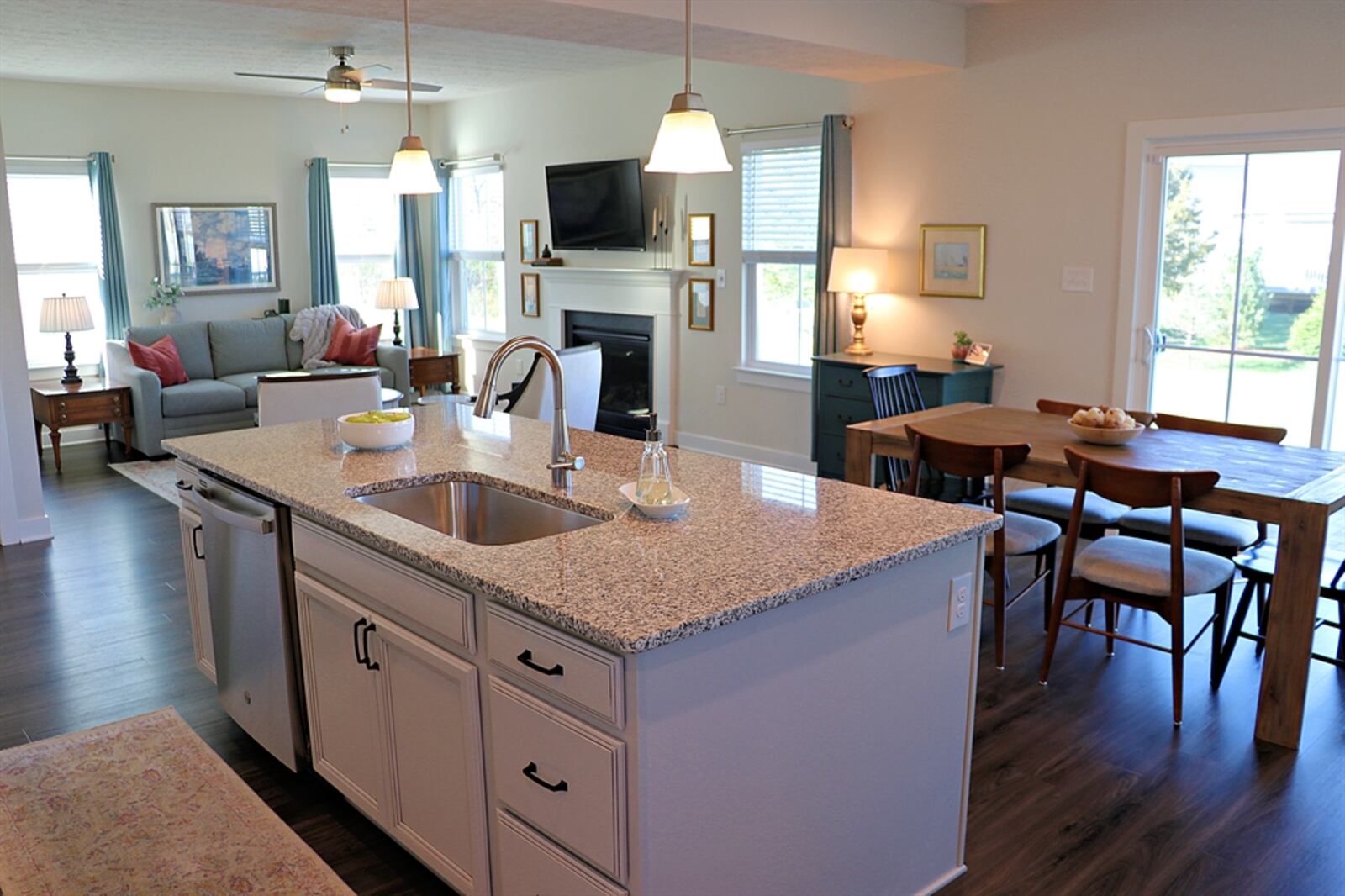 A generous island divides the dining room from the kitchen’s preparation area. The island has an extended counter to allow for bar seating.