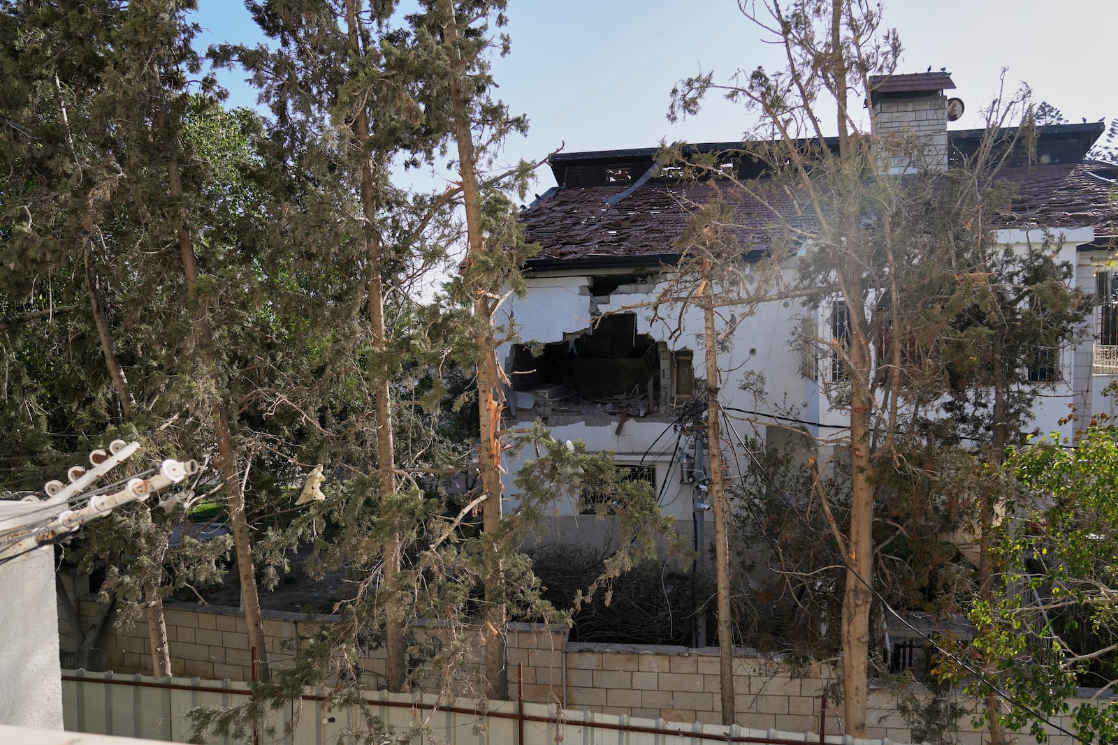 The impact of a projectile is visible on the wall of the U.N. guesthouse, where United Nations workers were located when the building was struck, leaving one staff member dead and five others injured in Deir al-Balah, central Gaza, Wednesday, March 19, 2025. (AP Photo/Abdel Kareem Hana)