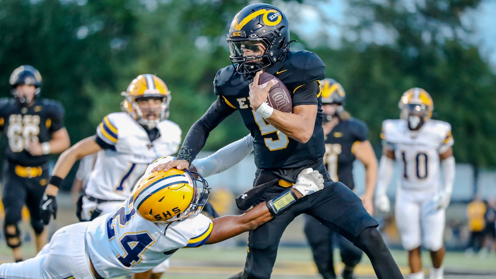 Cutline: Centerville High School junior Shane Cole stiff arms Springifeld's Jamar Montgomery during their game on Friday night at Centerville Stadium. The Wildcats won 17-3. Michael Cooper/CONTRIBUTED