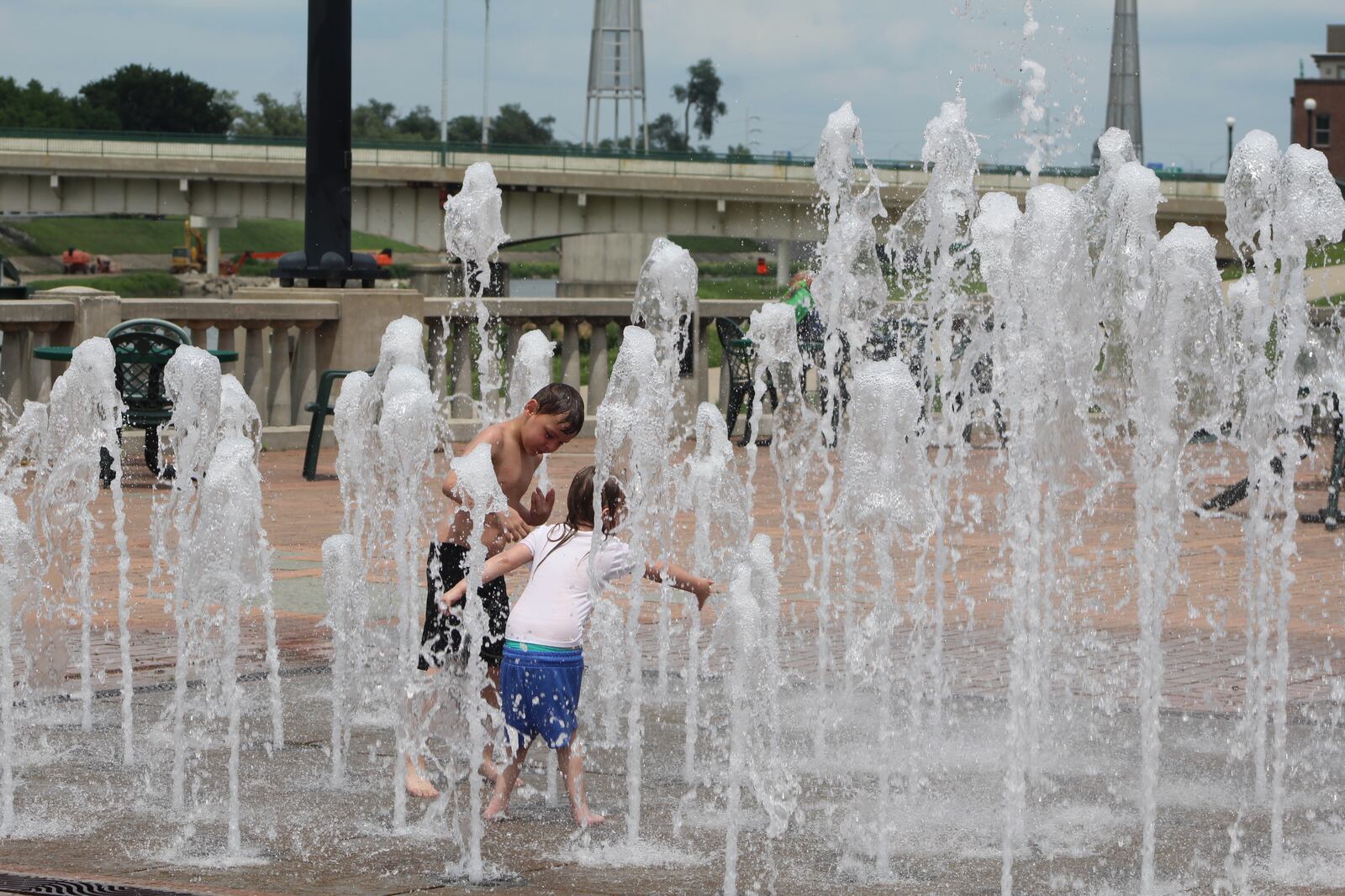 Kids play in RiverScape's interactive fountain on a recent weekday. CORNELIUS FROLIK / STAFF