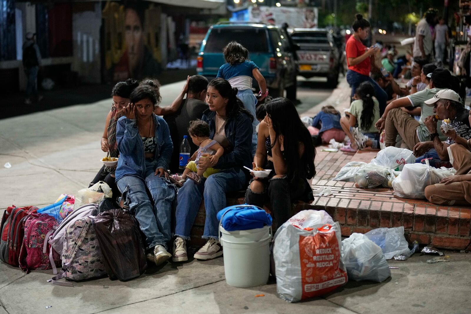 People displaced by violence in towns across the Catatumbo region, where rebels of the National Liberation Army (ELN) have been clashing with former members of the Revolutionary Armed Forces of Colombia, arrive for shelter at a soccer stadium in Cúcuta, Colombia, Sunday, Jan. 19, 2025. (AP Photo/Fernando Vergara)