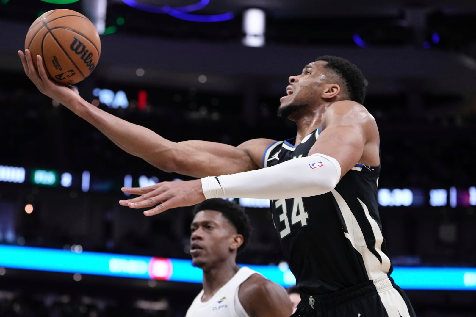 Milwaukee Bucks' Giannis Antetokounmpo shoots past Cleveland Cavaliers' De'Andre Hunter during the first half of an NBA basketball game Sunday, Mar. 9, 2025, in Milwaukee. (AP Photo/Morry Gash)