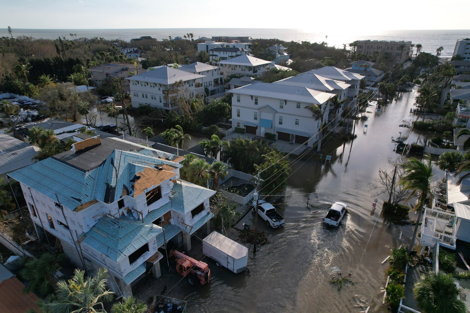 A truck drives down a flooded street in Siesta Key, Fla., following the passage of Hurricane Milton, Thursday, Oct. 10, 2024. (AP Photo/Rebecca Blackwell)