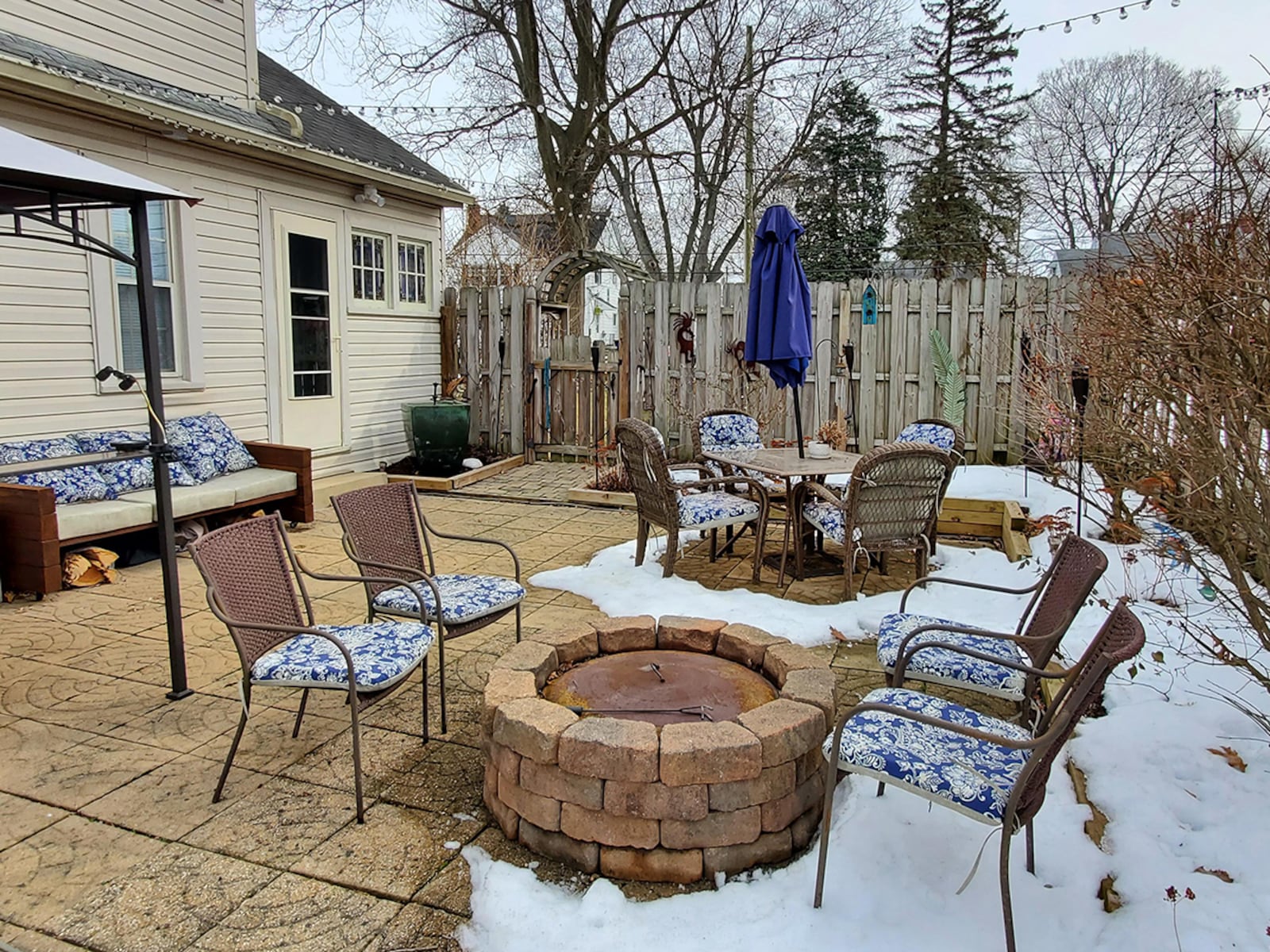 In back is a wood privacy fence with a decorative arbor over the gate. There is a large stamped concrete patio, a firepit and several raised flower/garden beds. The home sits on a third of an acre. CONTRIBUTED PHOTO