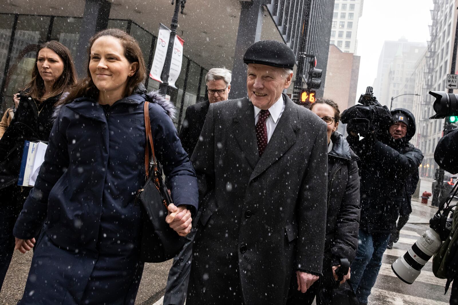 Flanked by supporters and holding hands with his daughter Nicole, former Illinois House Speaker Michael Madigan walks out of the Dirksen Federal Courthouse in Chicago, Wednesday, Feb. 12, 2025. (Ashlee Rezin/Chicago Sun-Times via AP)