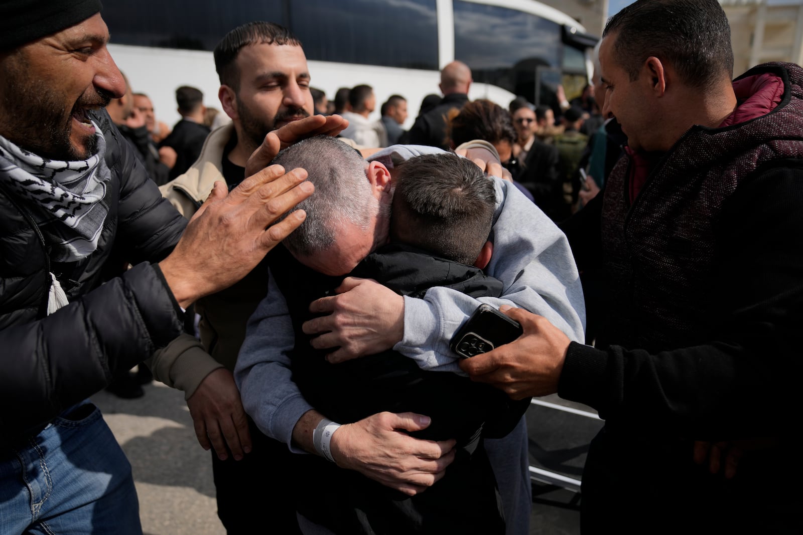 Palestinian prisoners are greeted as they exit a Red Cross bus after being released from Israeli prison following a ceasefire agreement between Israel and Hamas, in the West Bank city of Ramallah, Saturday Feb. 1, 2025. (AP Photo/Nasser Nasser)