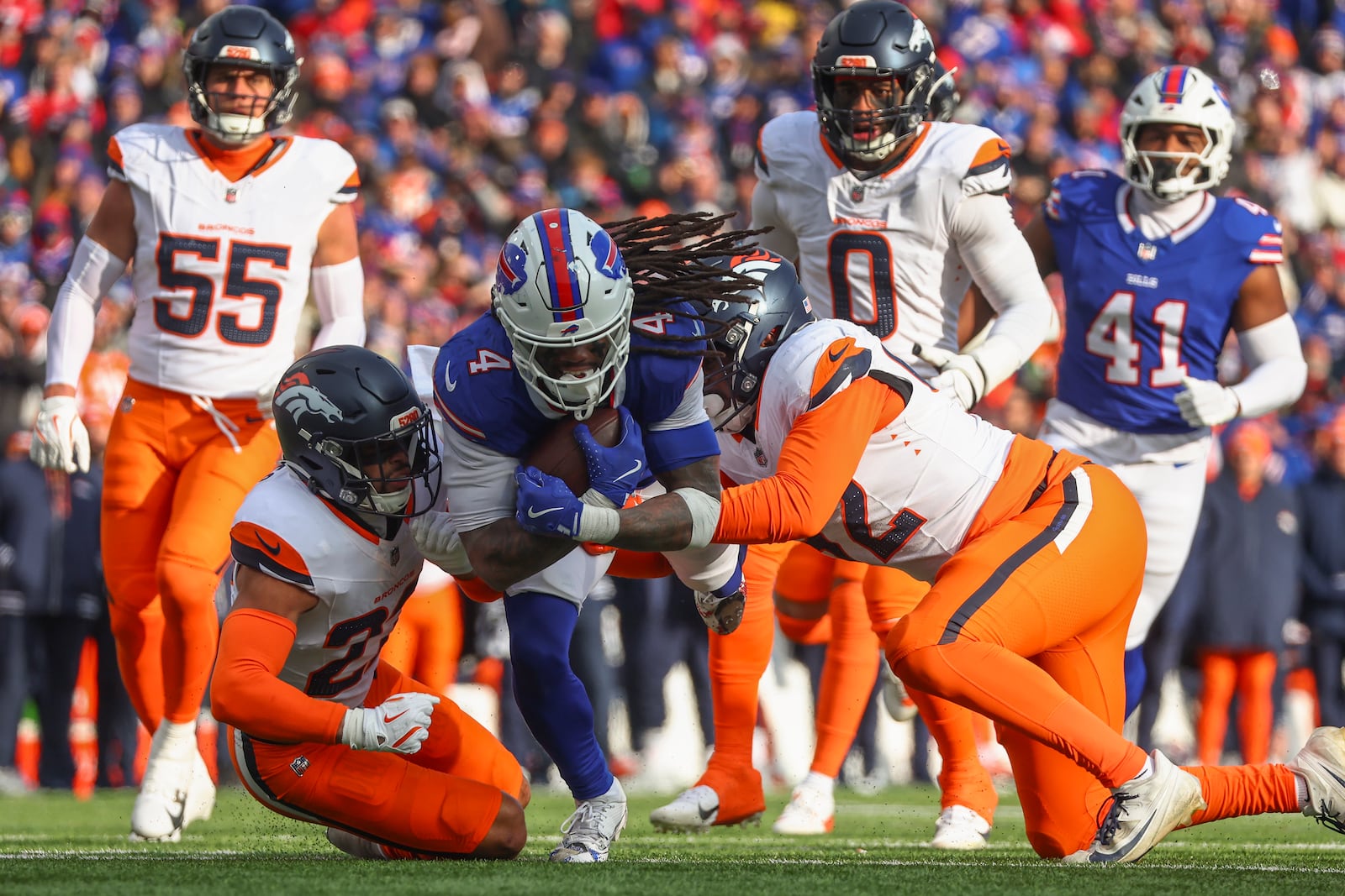 Buffalo Bills running back James Cook (4) carries the ball for a first down against the Denver Broncos during the third quarter of an NFL wild card playoff football game, Sunday, Jan. 12, 2025, in Orchard Park, N.Y. (AP Photo/Jeffrey T. Barnes)