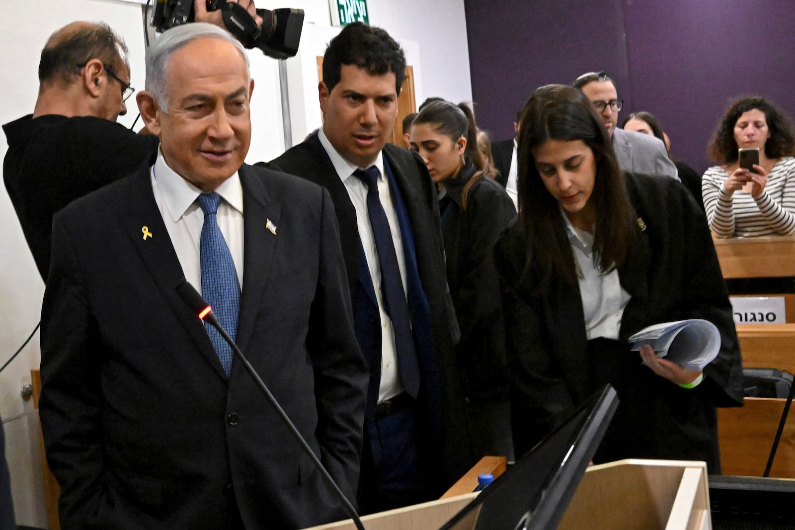 Israeli Prime Minister Benjamin Netanyahu, left, attends the fifth day of testimony in his trial on corruption charges at the district court in Tel Aviv, Israel, on Monday, Dec. 23, 2024. (Debbie Hill/Pool Photo via AP)