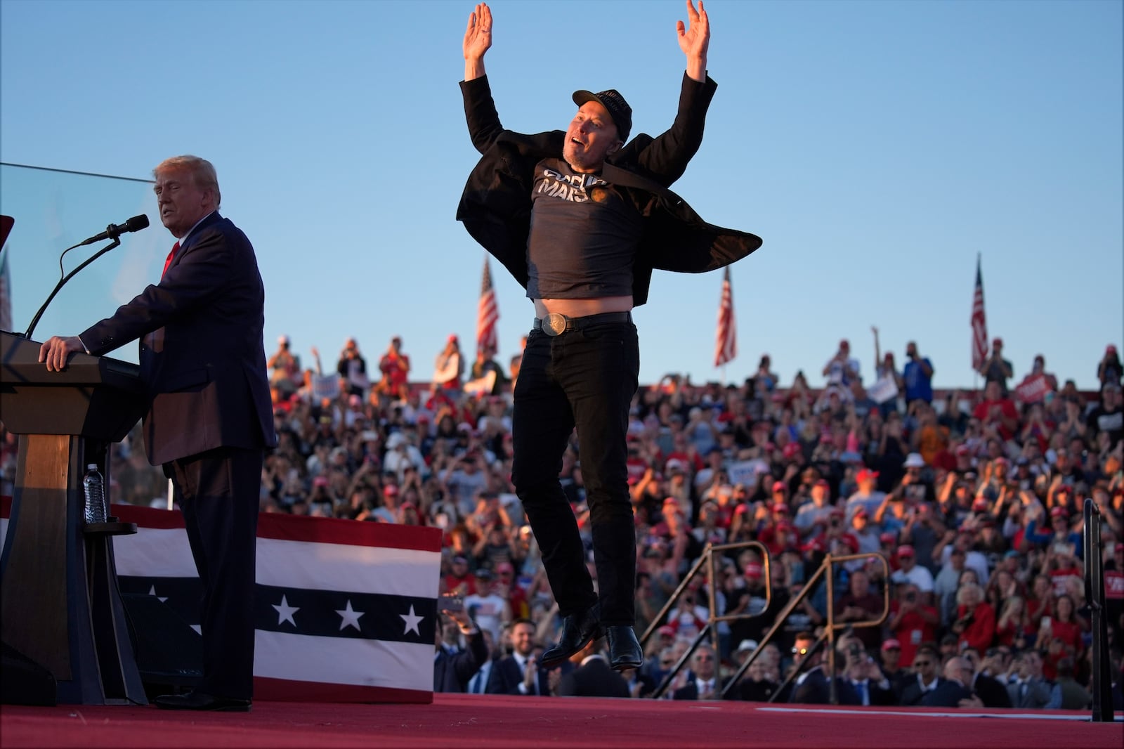 FILE - Elon Musk jumps on the stage as Republican presidential nominee former President Donald Trump speaks during a campaign rally at the Butler Farm Show on Oct. 5, 2024, in Butler, Pa. (AP Photo/Evan Vucci, File)