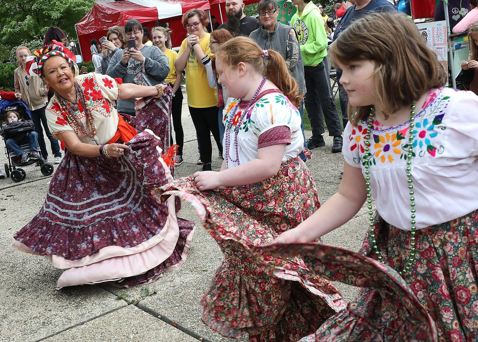 Beatric Koehler teaches Phoenyx Meadows (left) and Olivia Artrip a Mexican dance during last year’s CultureFest. BILL LACKEY/STAFF