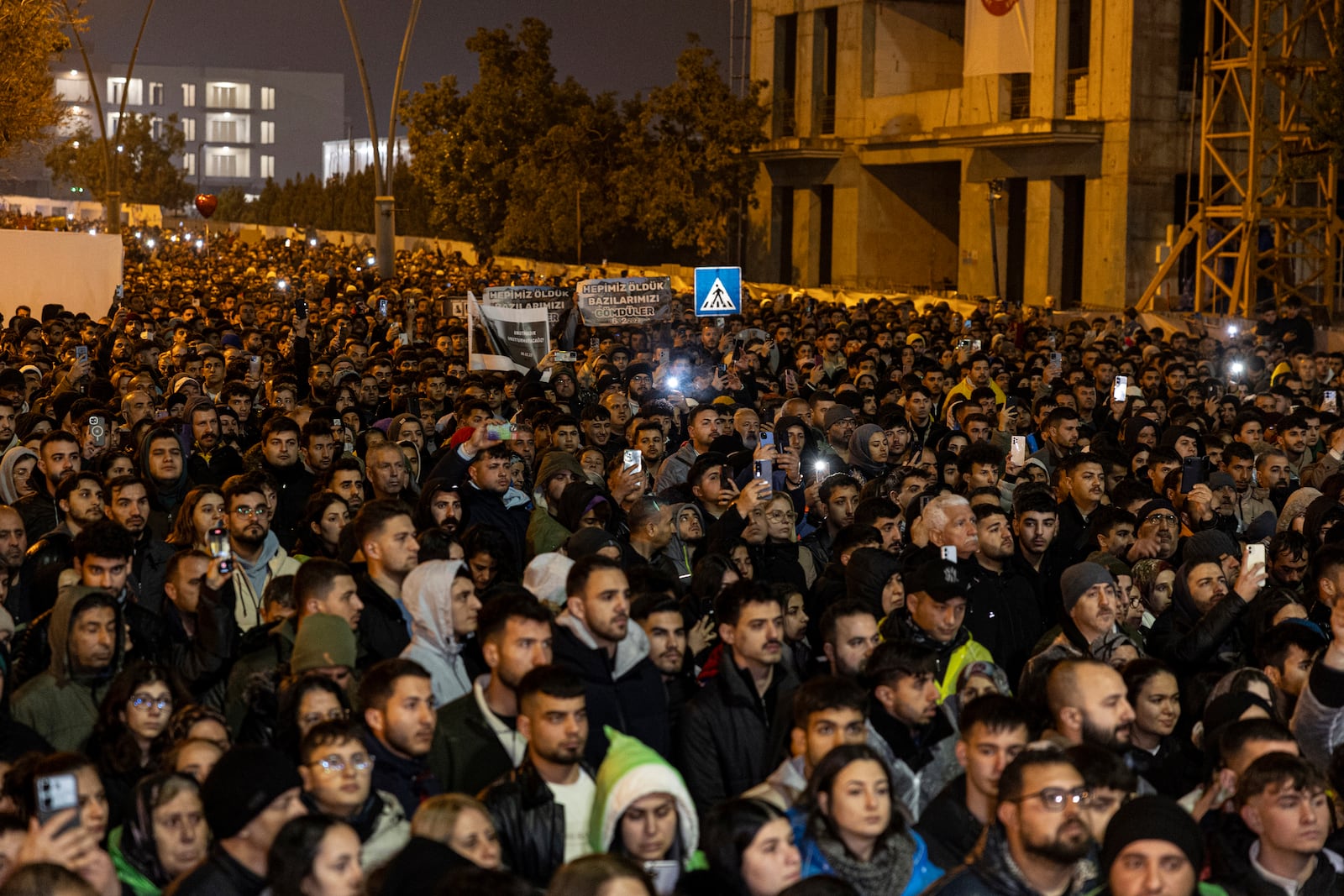 People gather to mark the two-year anniversary of the country's catastrophic earthquake, in Antakya, southern Turkey, early Thursday, Feb. 6, 2025. (Ugur Yildirim/Dia Photo via AP)