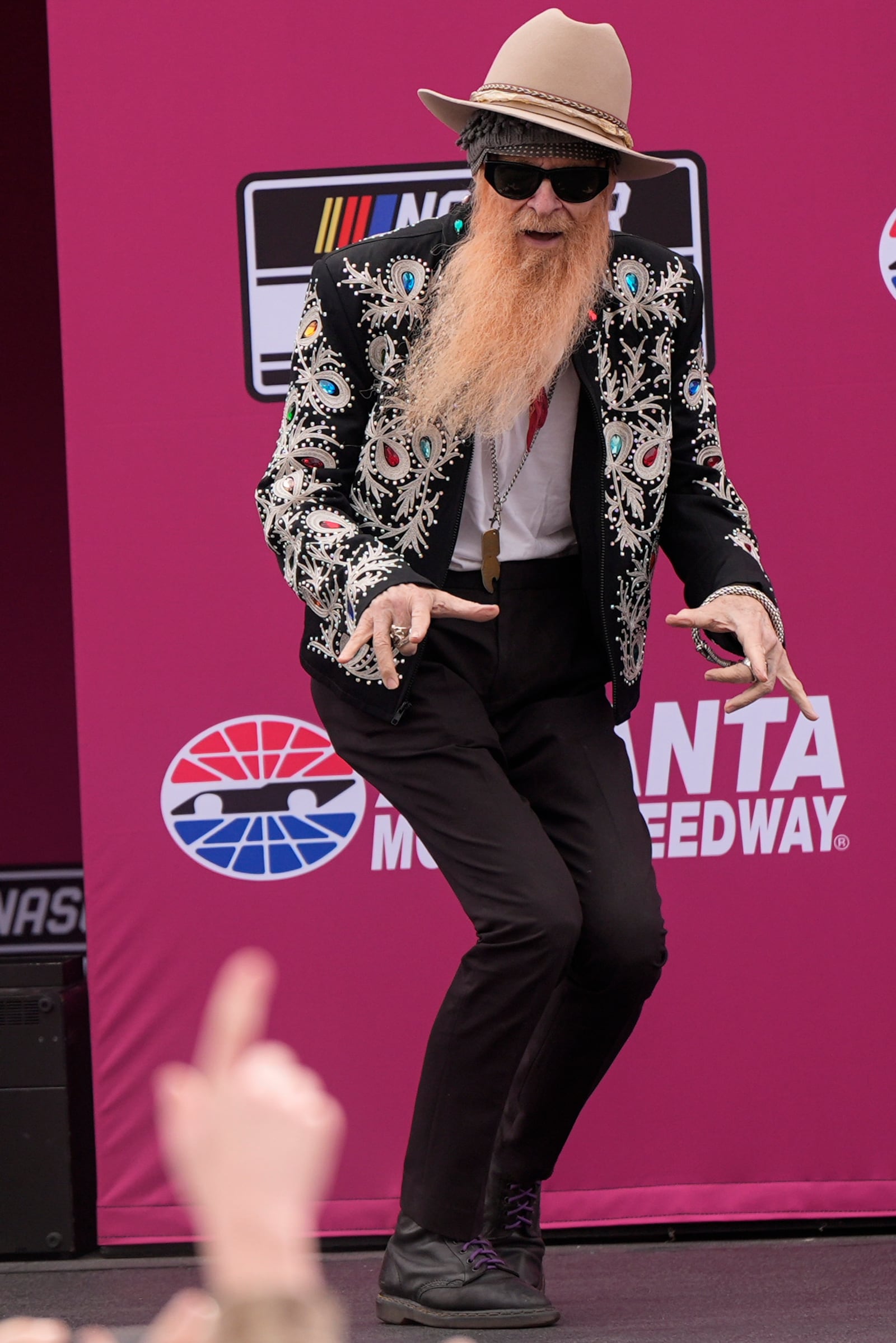 ZZ Top's Billy F Gibbons arrives before a NASCAR Cup Series auto race, Sunday, Feb. 23, 2025, in Hampton, Ga. (AP Photo/Mike Stewart)