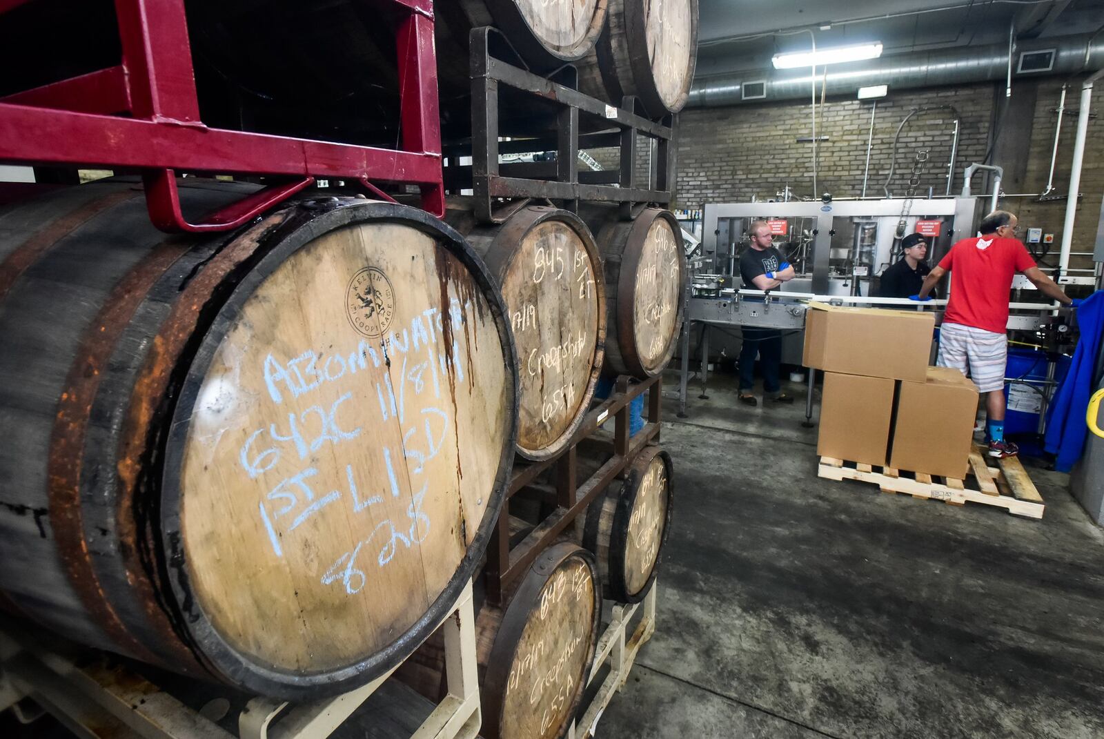 Beer is aged in barrels at Warped Wing Brewing Company Thursday, Dec. 19, 2019 on Wyandot Street in Dayton. NICK GRAHAM/STAFF