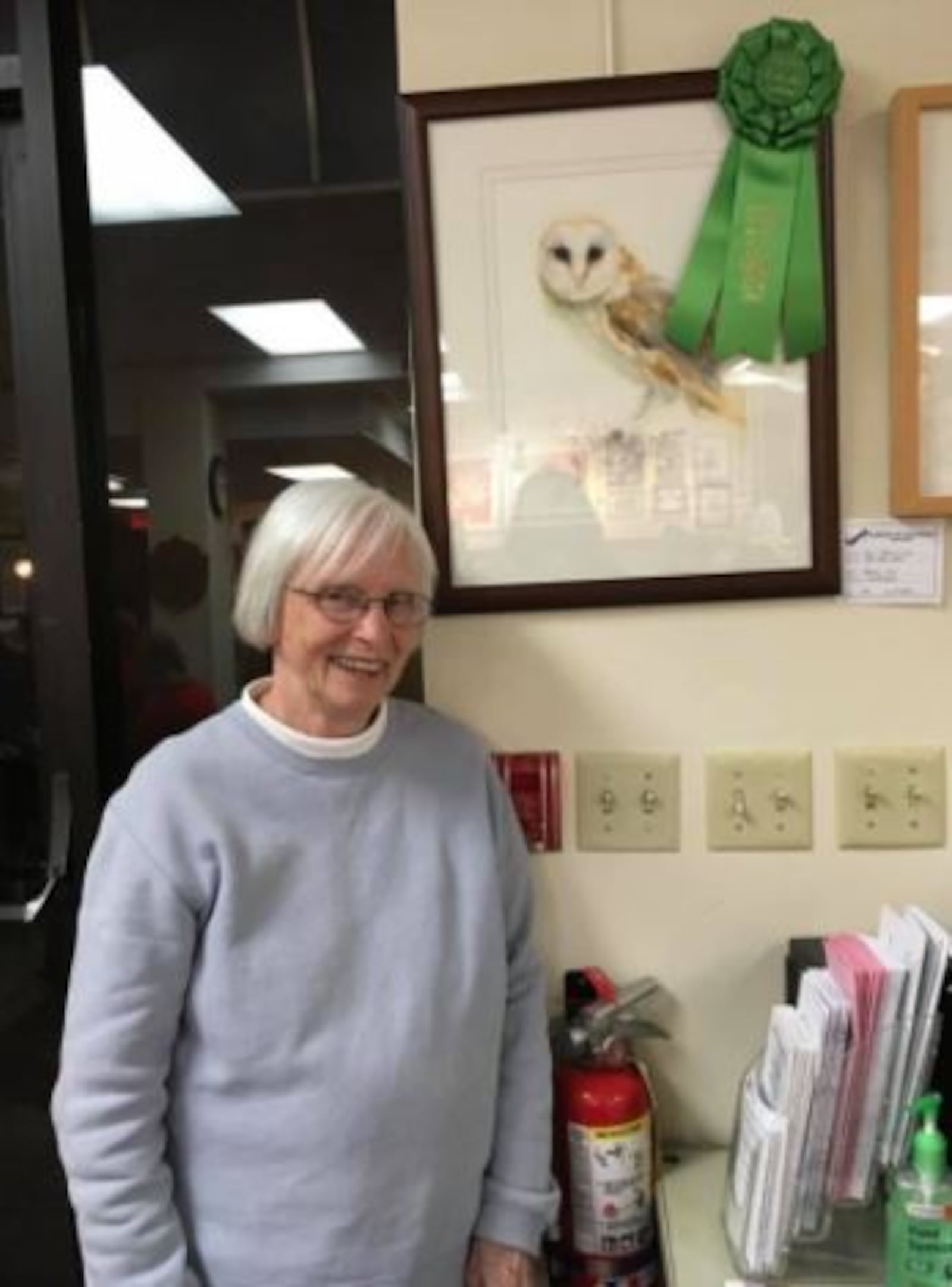 Artist Sue Brezine and one of her award-winning paintings.