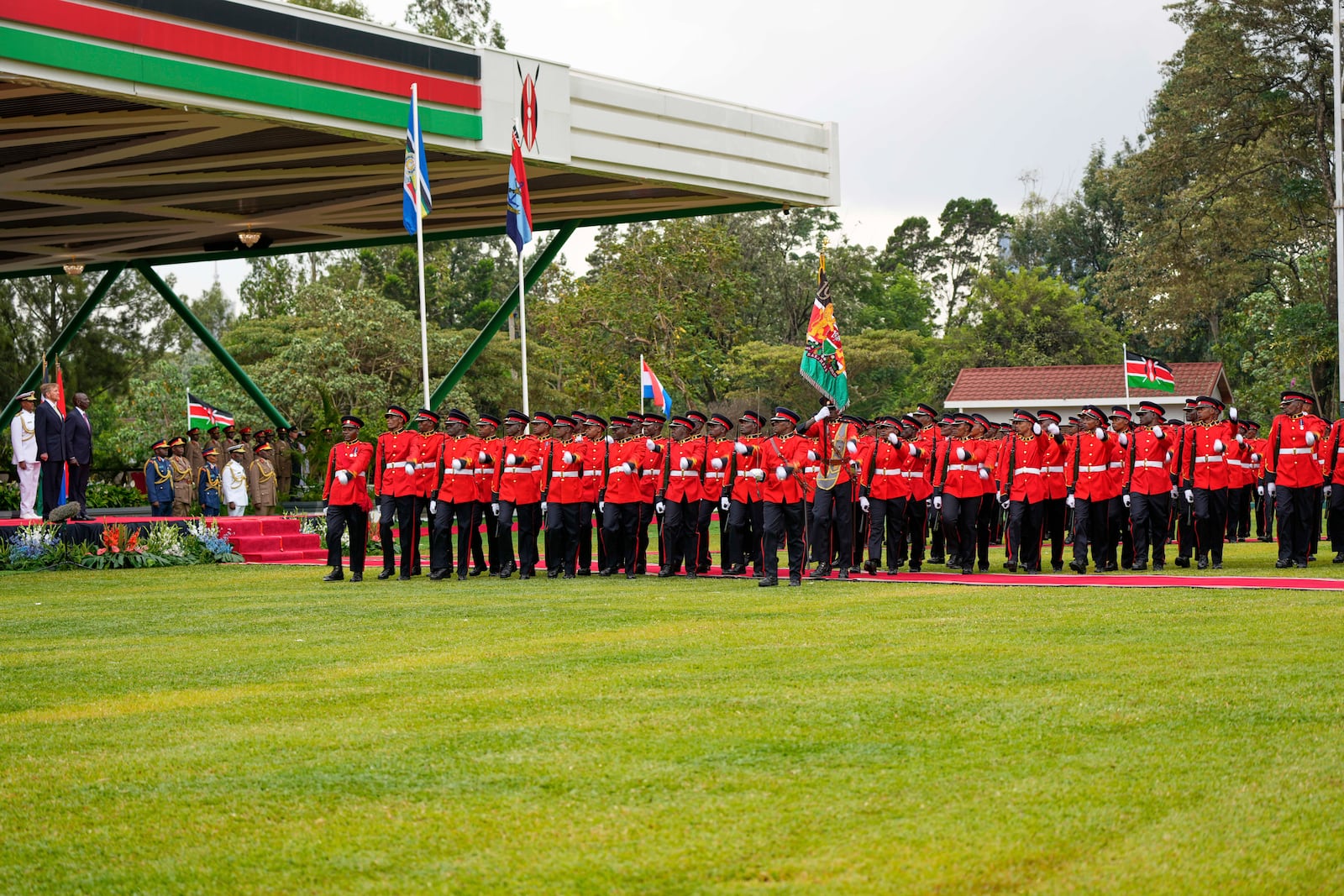 King Willem-Alexander of the Netherlands, center-left, and Kenya's President William Ruto, center, observe the honor guard at State House in Nairobi, Kenya Tuesday, March 18, 2025. (AP Photo/Brian Inganga)