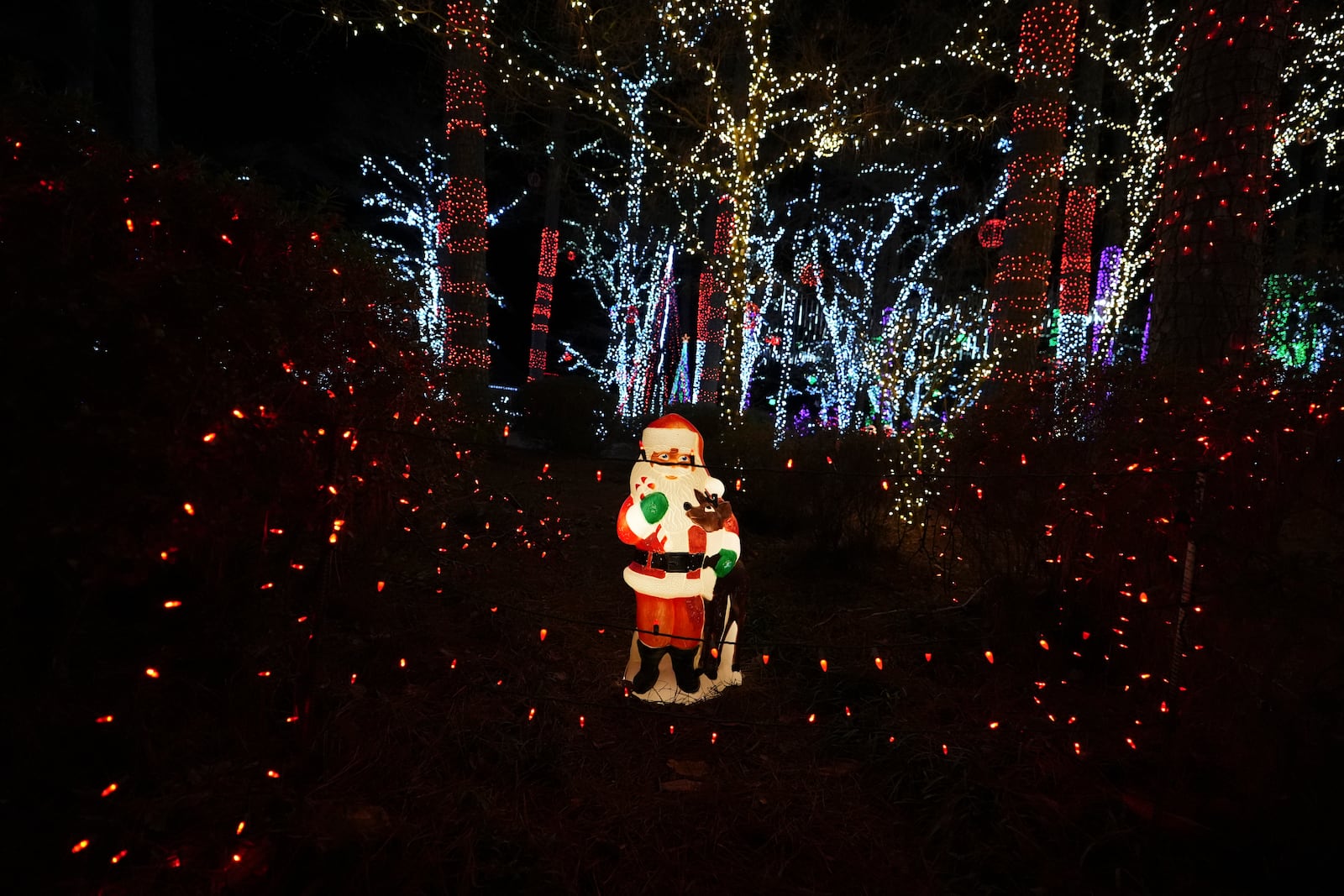 A Santa decoration is seen among holiday lights at the Lights of Joy display Monday, Dec. 16, 2024, in Kennesaw, Ga. (AP Photo/Brynn Anderson)