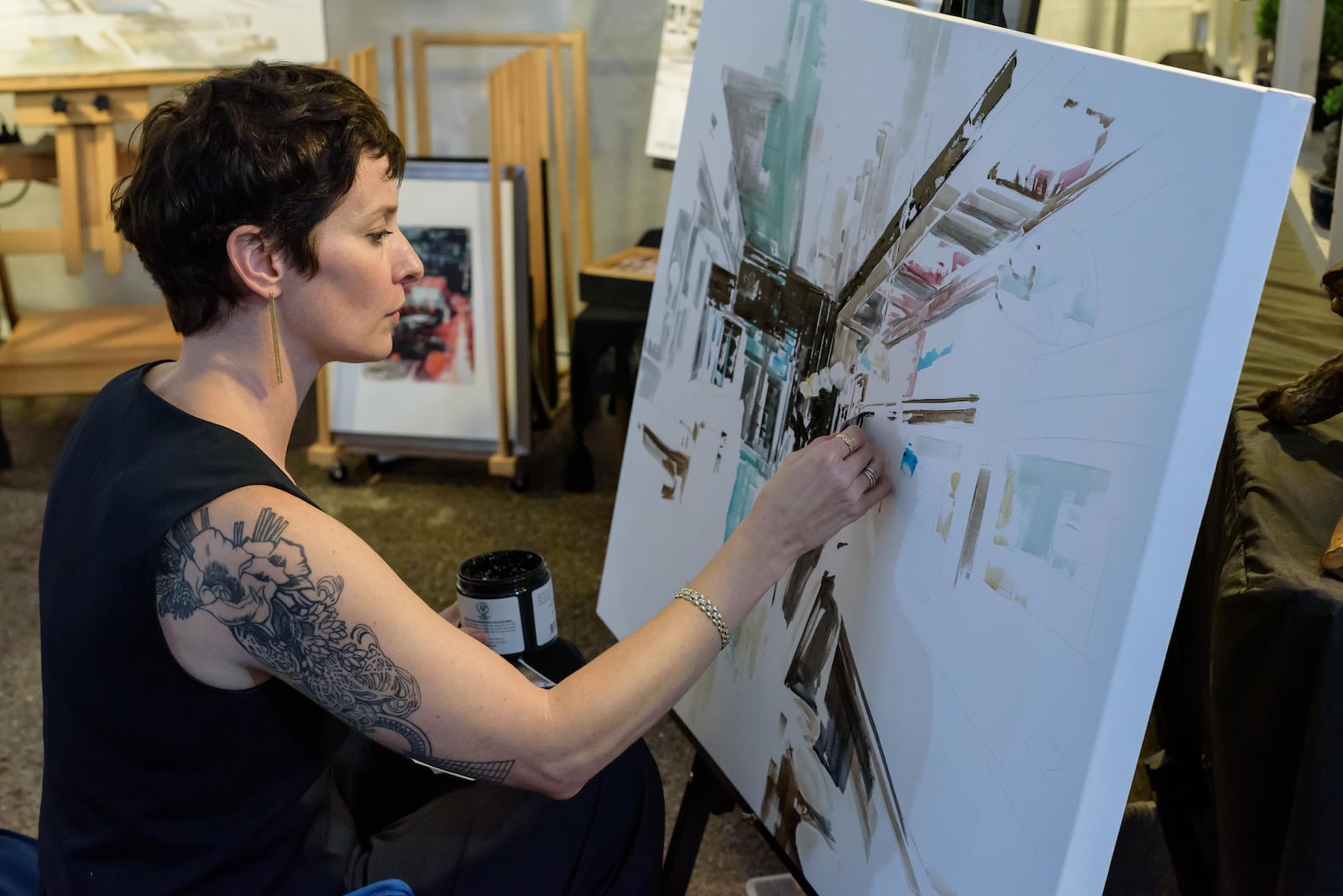 Cleveland-based artist Ashley Sullivan works on a new painting at The Dayton Art Institute’s 53rd Oktoberfest on Saturday, Sept. 28, 2024. TOM GILLIAM / CONTRIBUTING PHOTOGRAPHER