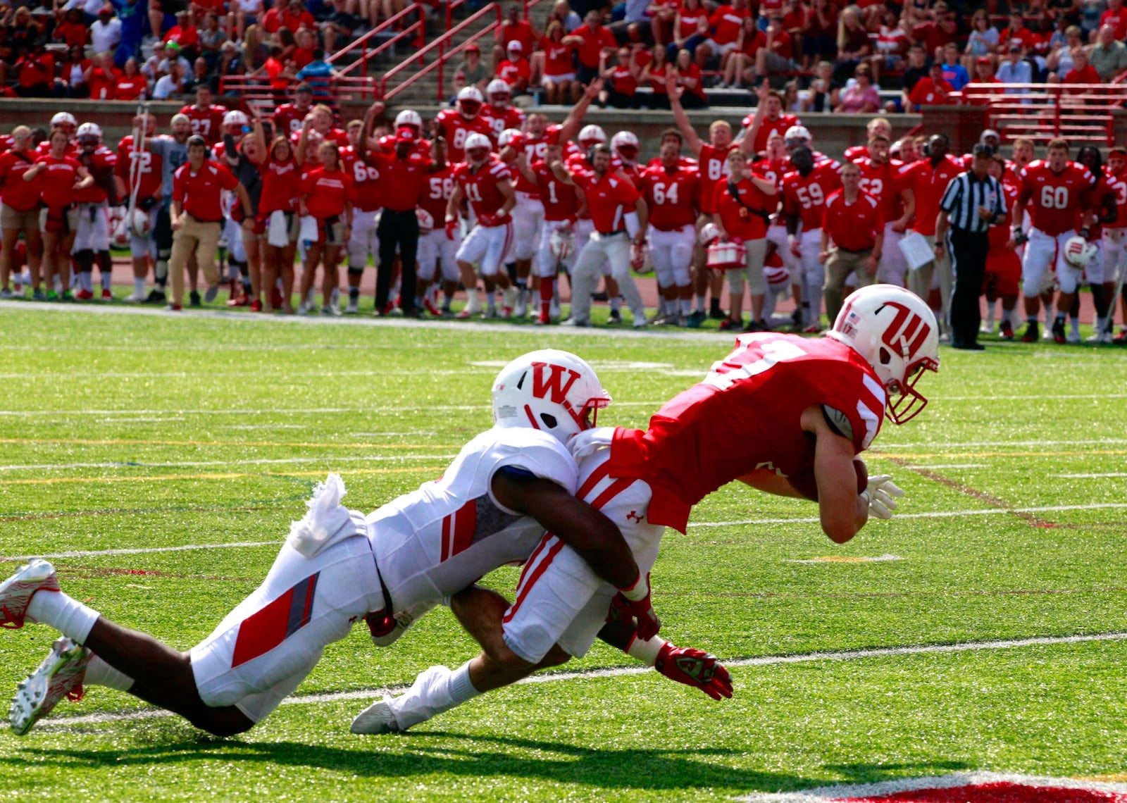 Wittenberg’s Luke Landis makes a diving catch in the end zone against Wabash’s Delon Pettiford to give Wittenberg a 21-14 lead in the third quarter on Saturday, Sept. 24, 2016, at Edwards-Maurer Field in Springfield. David Jablonski/Staff