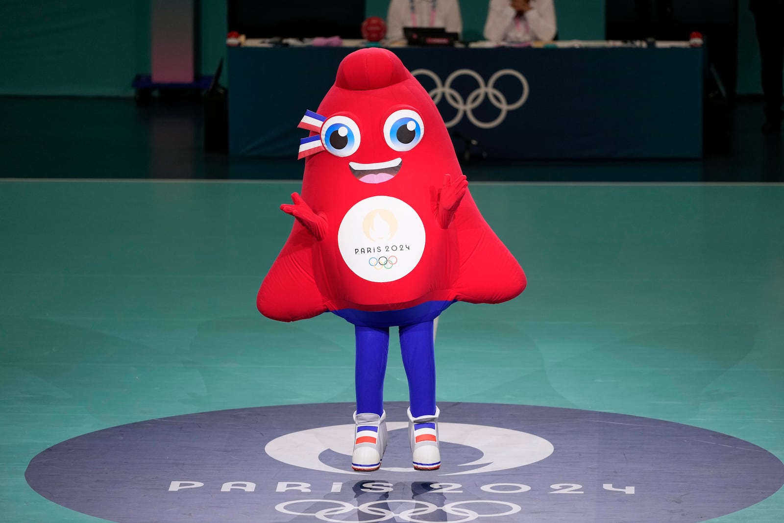 FILE - Phryge, the Olympics 2024 mascot dances at the South Paris Arena, during the men's handball match between Denmark and Egypt at the 2024 Summer Olympics, Monday, July 29, 2024, in Paris, France. (AP Photo/Brian Inganga, File)