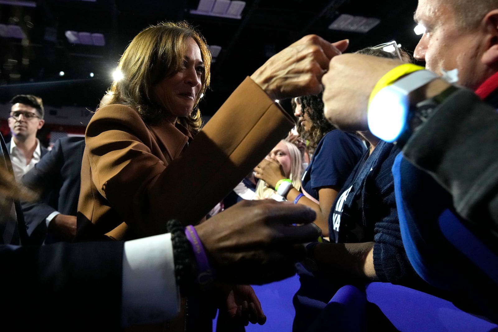 Democratic presidential nominee Vice President Kamala Harris fist-bumps a supporter after speaking at a campaign rally at the Wings Event Center in Kalamazoo, Mich. (AP Photo/Jacquelyn Martin)