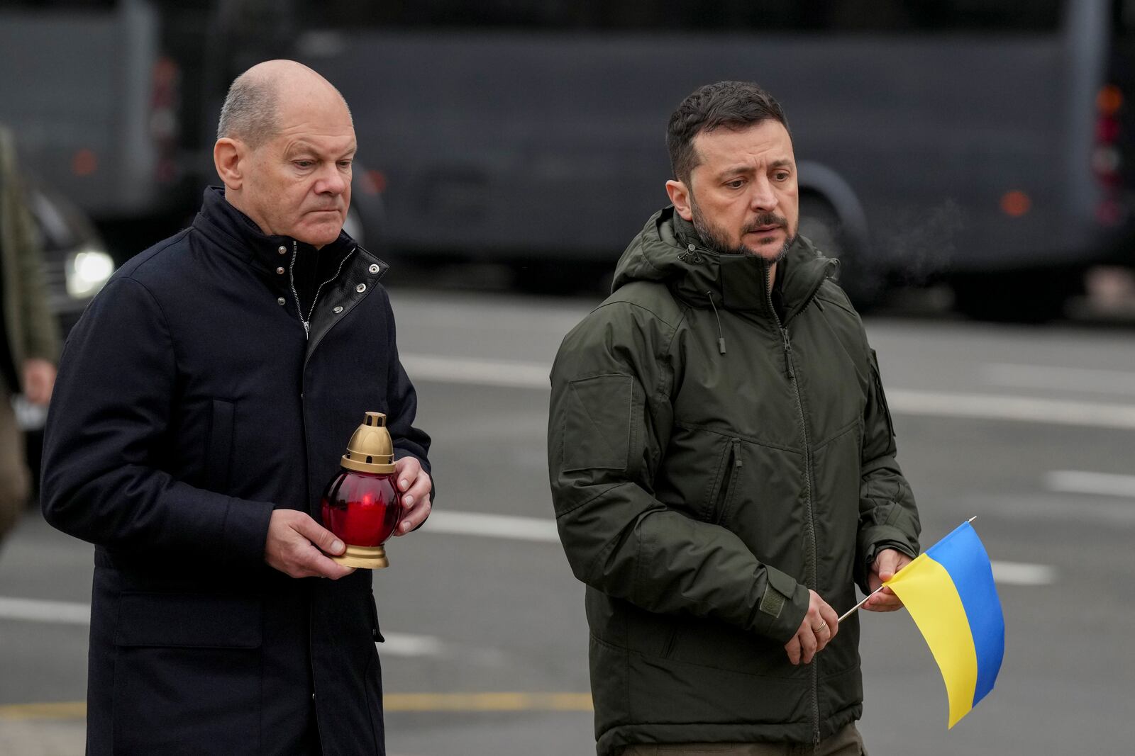 Ukraine's President Volodymyr Zelenskyy, right, and German Chancellor Olaf Scholz attend a ceremony of honoring fallen soldiers near the People's Memorial of National Memory in Kyiv, Ukraine, Monday, Dec.2, 2024. (AP Photo/Evgeniy Maloletka)