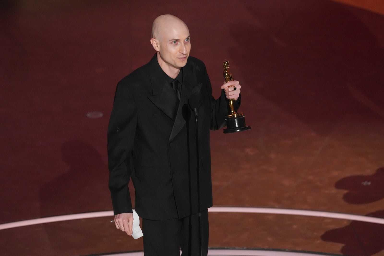 Daniel Blumberg accepts the award for best original score for "The Brutalist" during the Oscars on Sunday, March 2, 2025, at the Dolby Theatre in Los Angeles. (AP Photo/Chris Pizzello)