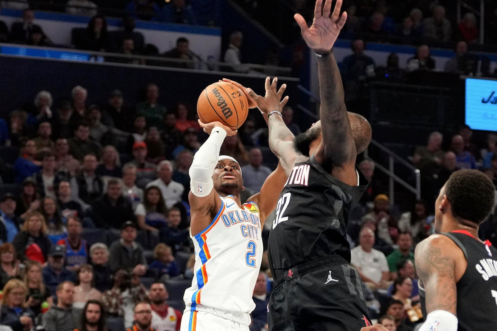 Oklahoma City Thunder guard Shai Gilgeous-Alexander, left, shoots over Houston Rockets forward Jeff Green, right, during the first half of an NBA basketball game, Monday, March 3, 2025, in Oklahoma City. (AP Photo/Kyle Phillips)