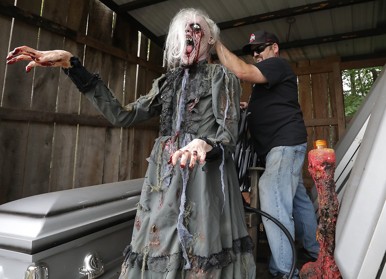 Paul Deady sets up an animatronic figure as he works on the Terror Maze. BILL LACKEY/STAFF