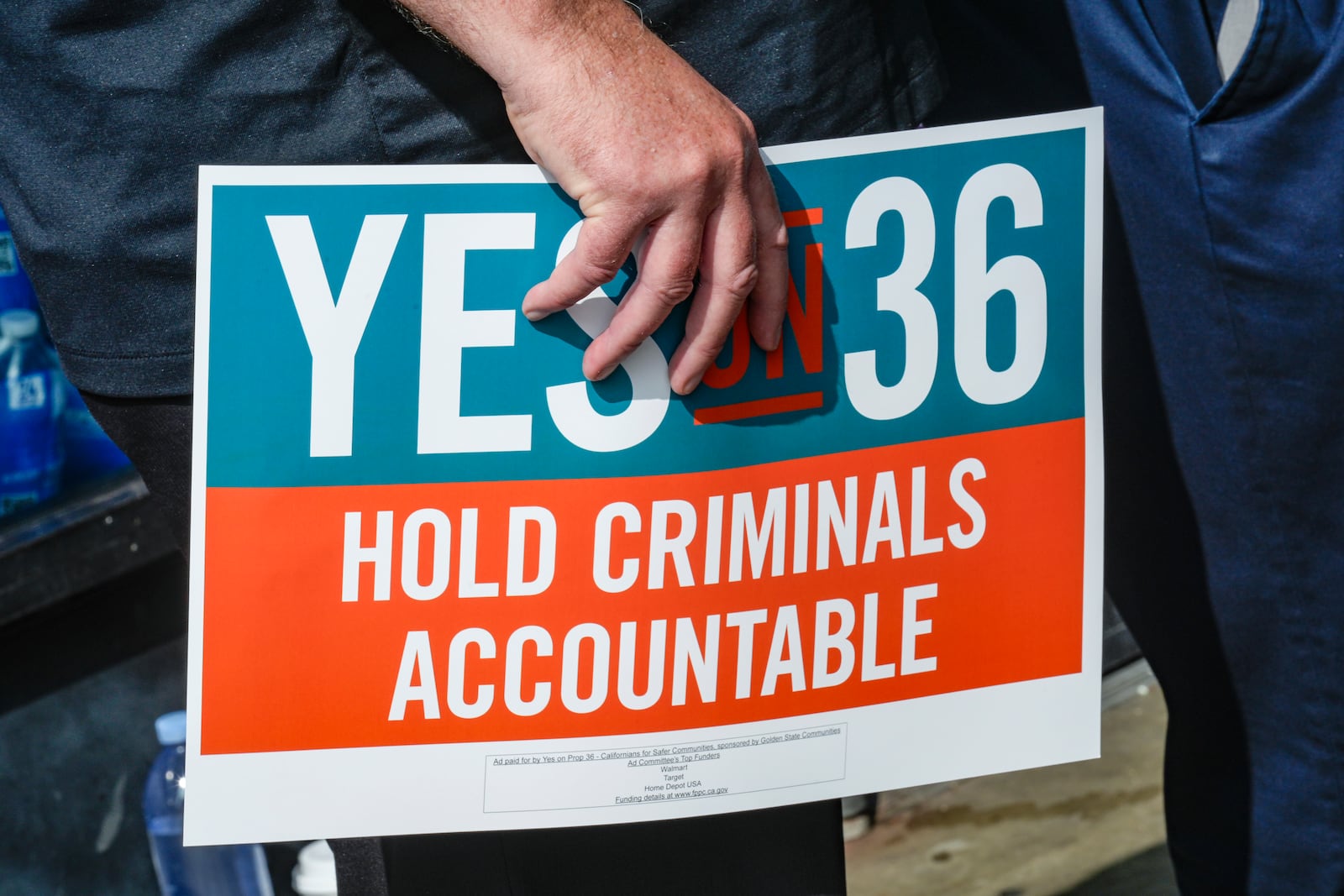 FILE - 7-Eleven leadership and franchisees support the Yes on Prop 36 campaign outside the 7-Eleven that was robbed by about 50 juveniles in late September in Los Angeles during a news conference, Thursday, Oct. 10, 2024. (AP Photo/Damian Dovarganes,File)