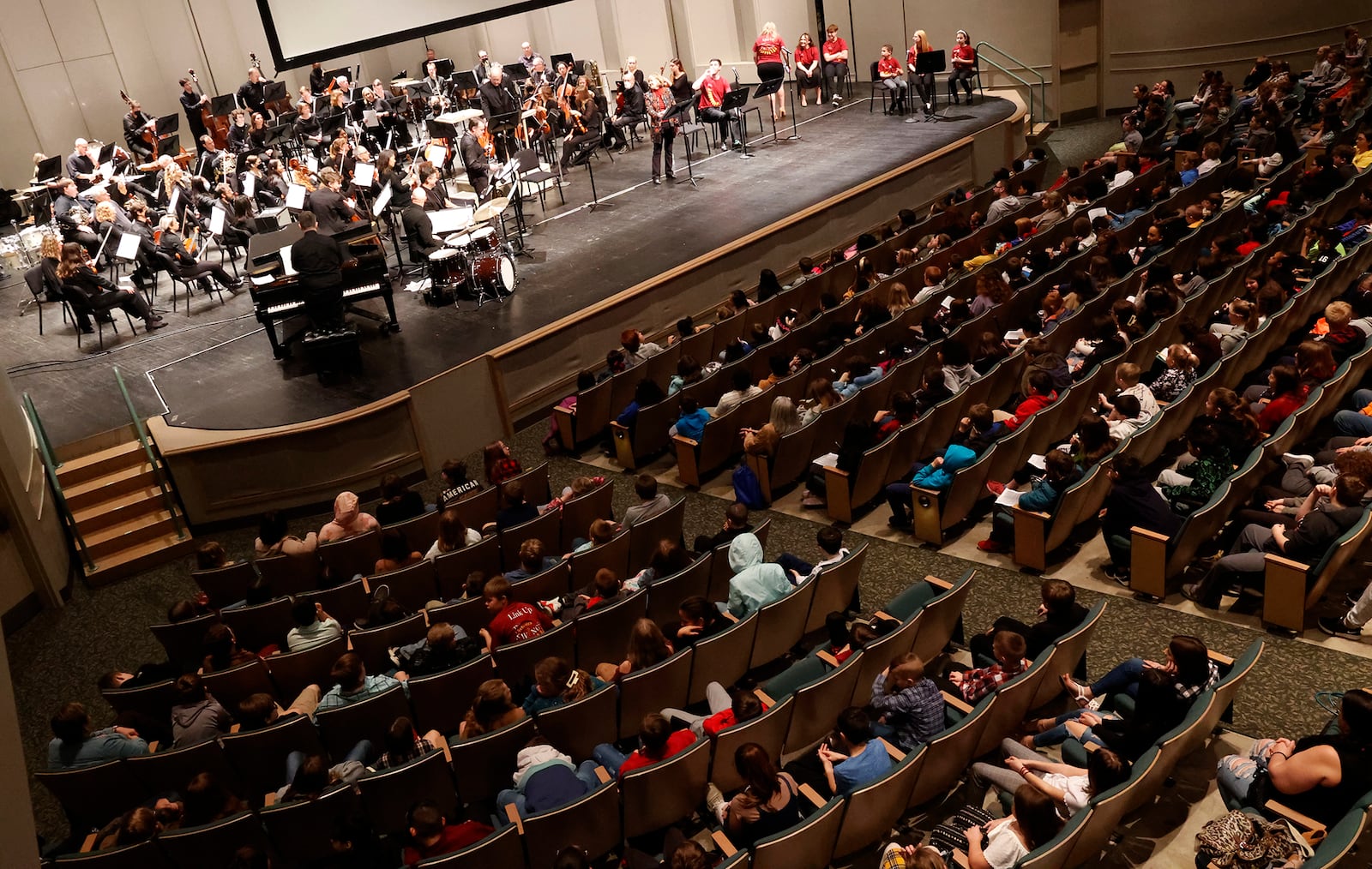 Students at Kuss Auditorium listen to the Springfield Symphony Orchestra Thursday, Feb. 23, 2023 during the Link Up: The Orchestra Swings music program. The students, in grades 3-5, were treated to an interactive performance with the orchestra and the jazz ensemble while exploring elements that contribute to the moment when the orchestra starts to swing. BILL LACKEY/STAFF