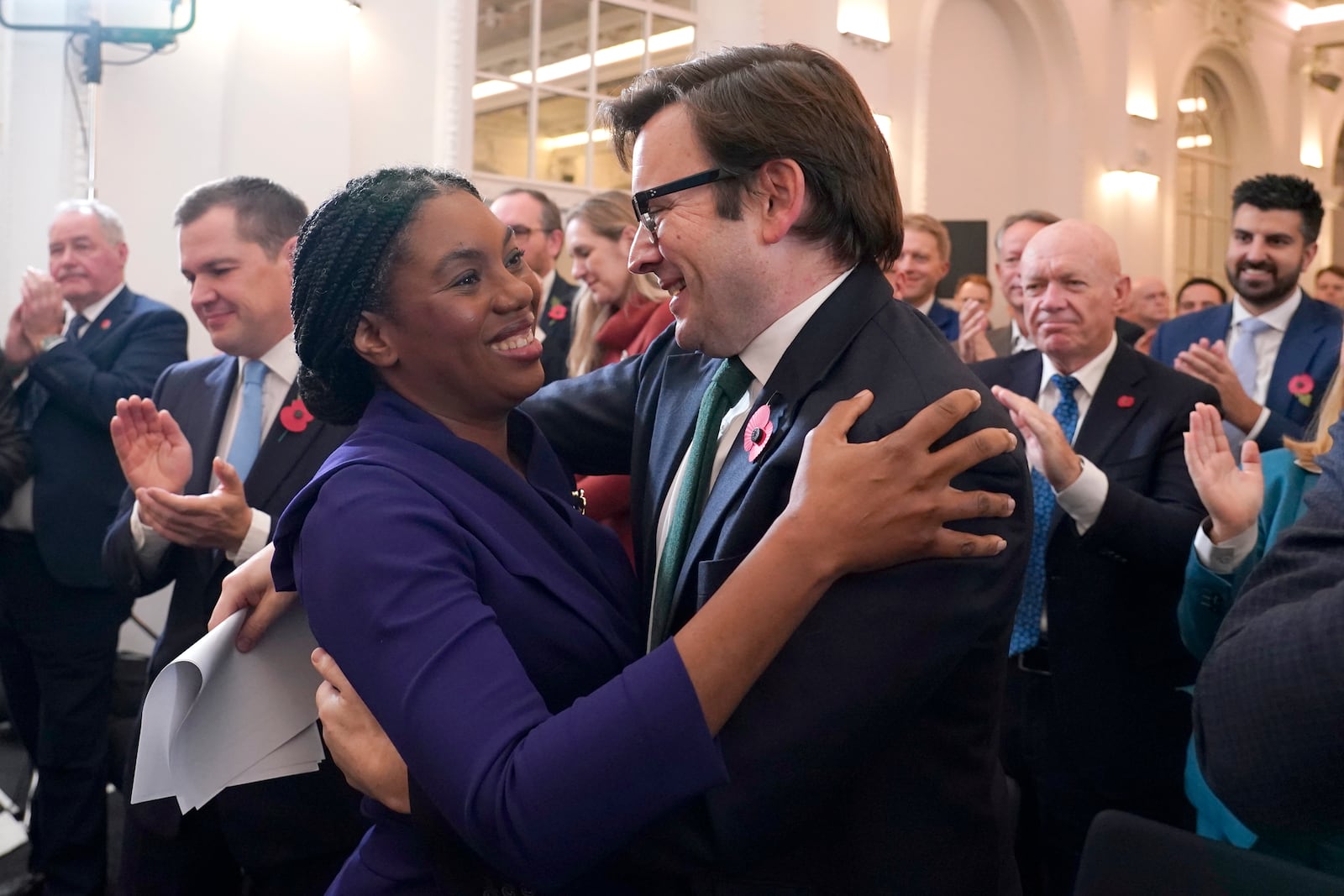 Britain's Member of Parliament Kemi Badenoch, left, embraces her husband Hamish Badenoch after being elected as the new leader of the opposition Conservative Party, in London, Saturday, Nov. 2, 2024. (AP Photo/Alberto Pezzali)