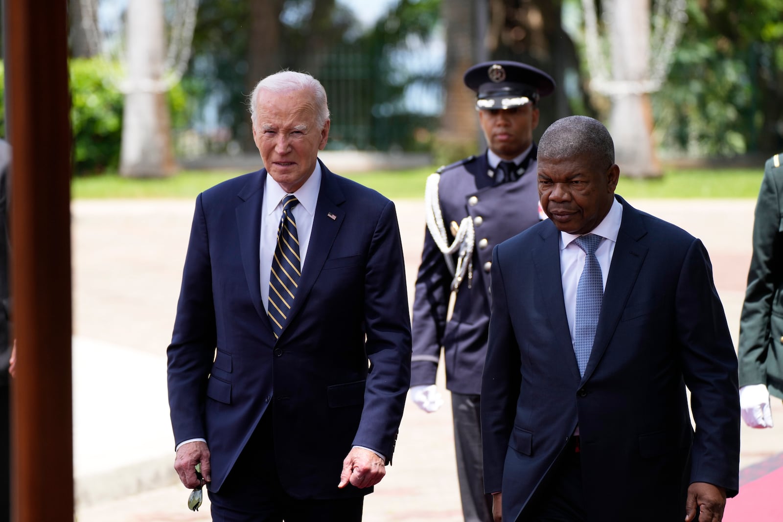 President Joe Biden arrives inspects the honor guard with Angola's President Joao Lourenco, at the presidential palace in the capital Luanda, Angola on Tuesday, Dec. 3, 2024. (AP Photo/Ben Curtis)