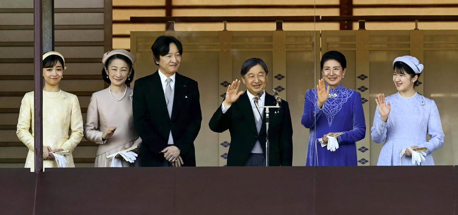 Japanese Emperor Naruhito, third right, accompanied by Empress Masako, second right, their daughter Princess Aiko, right, Crown Prince Akishino, third left, Crown Princess Kiko, second left, and Princess Kako, left, waves to well-wishers from the balcony of the Imperial Palace in Tokyo on the emperor's 65th birthday, Sunday, Feb. 23, 2025. (Kyodo News via AP)