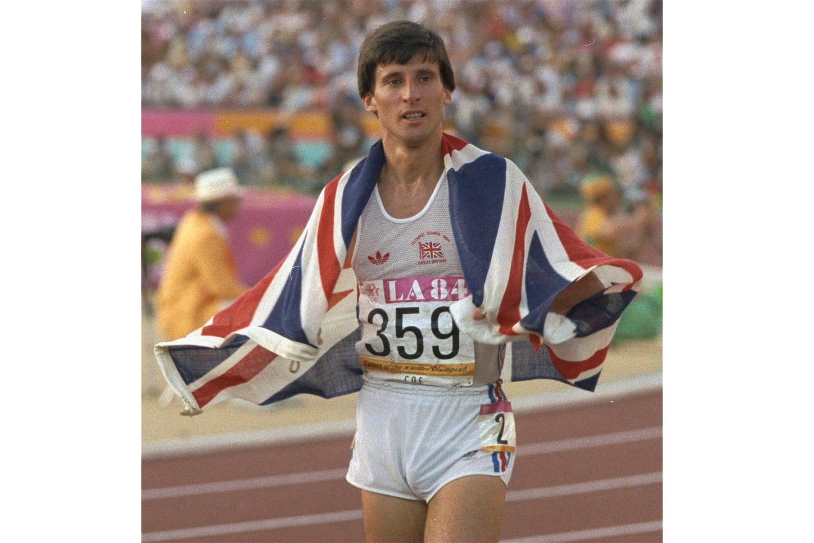 FILE - Great Britain's Sebastian Coe is draped in the Union Jack as he takes a victory lap after winning the 1500-meter finals Saturday, Aug. 11, 1984, at the Los Angeles Memorial Coliseum. (AP Photo/Rusty Kennedy, File)