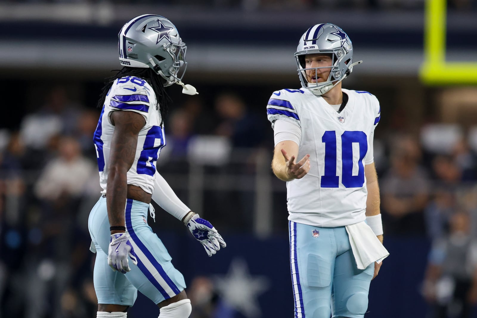 Dallas Cowboys quarterback Cooper Rush (10) and wide receiver CeeDee Lamb walk off the field after Rush threw an interception against the Houston Texans during the first half of an NFL football game, Monday, Nov. 18, 2024, in Arlington, Texas. (AP Photo/Gareth Patterson)