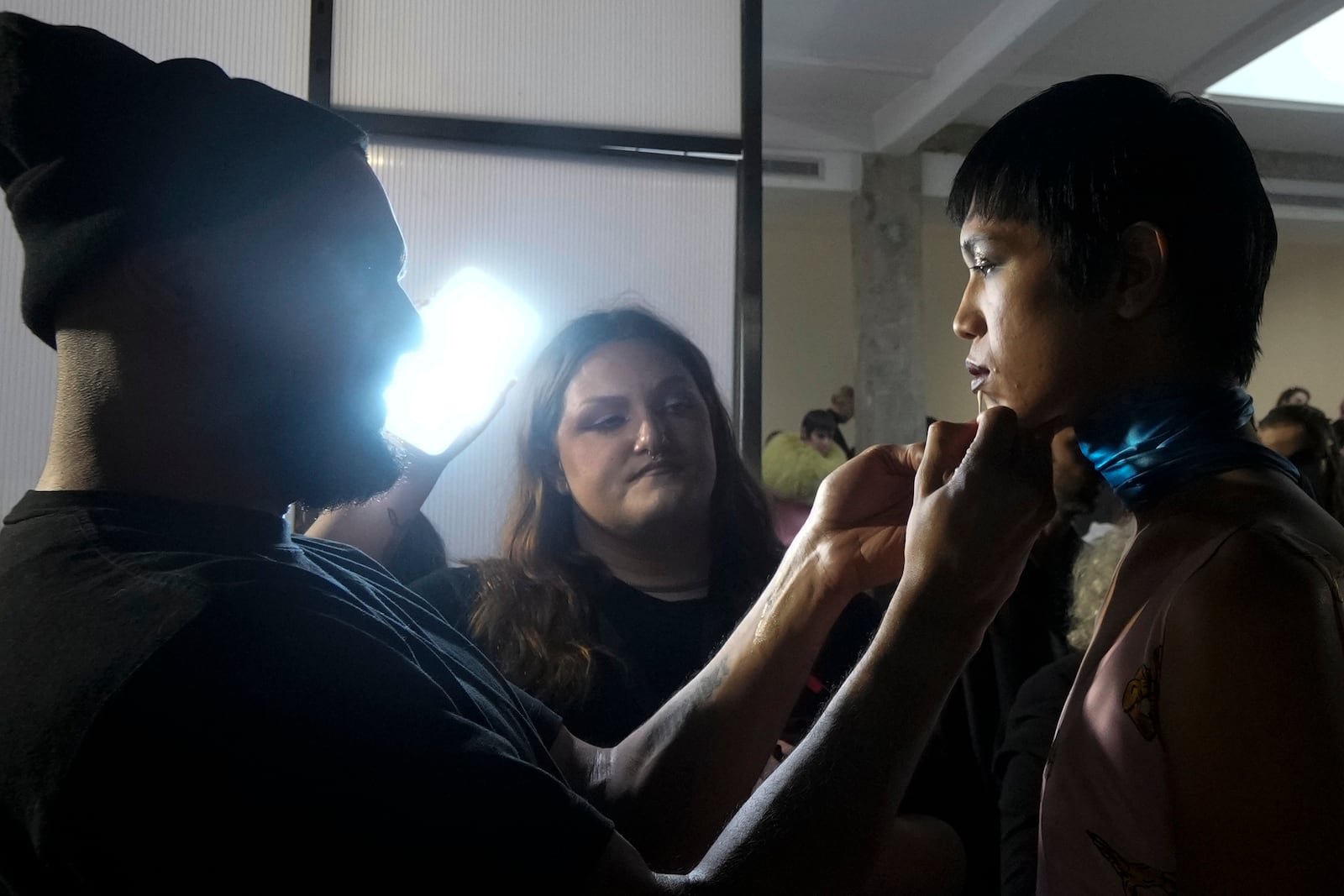 Model Dara gets made up by a make up artist in the backstage prior a Marni Fall/Winter 2025-2026 Womenswear fashion show, during the Fashion Week, in Milan, Italy, Wednesday, Feb. 26, 2025. (AP Photo/Luca Bruno)