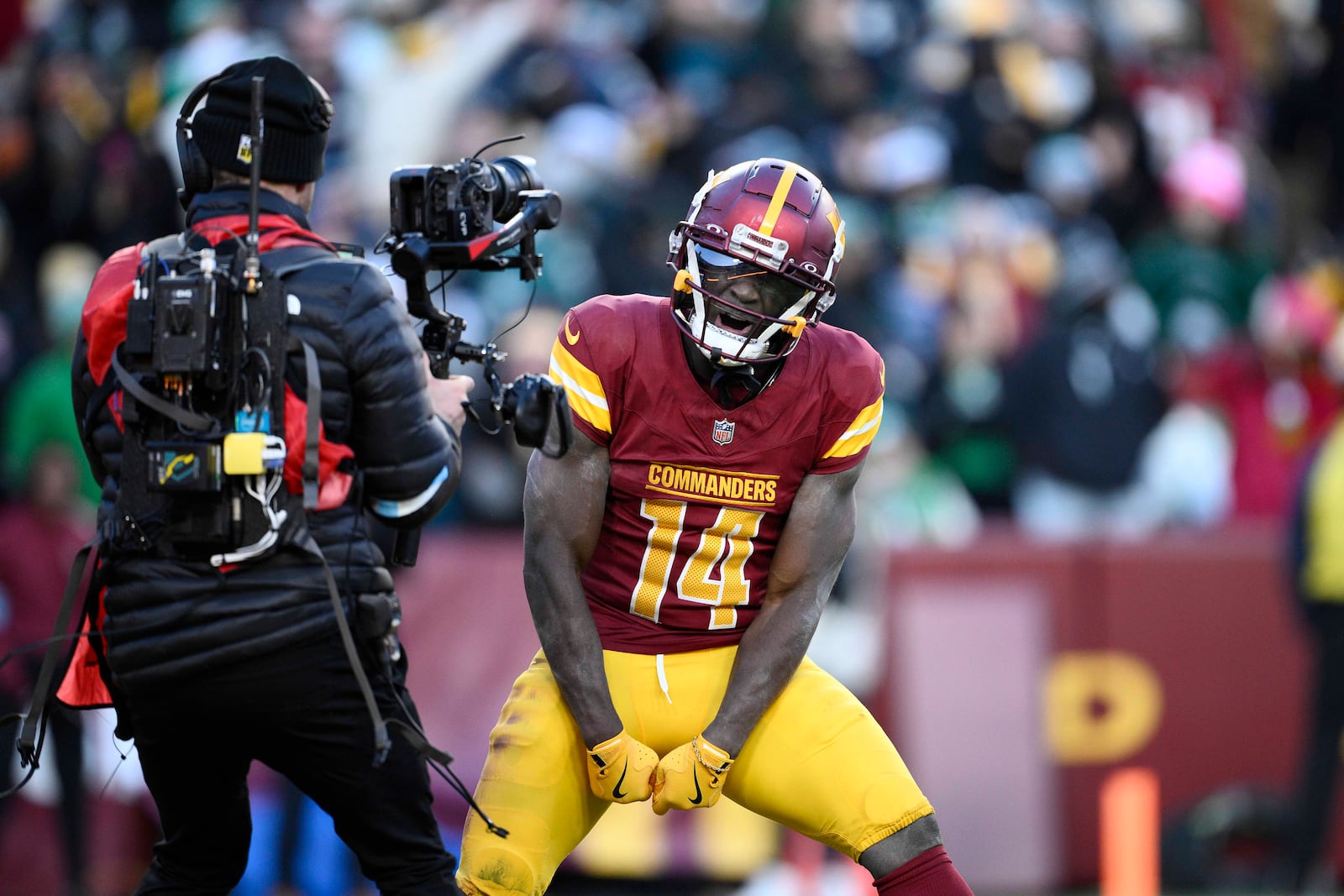 Washington Commanders wide receiver Olamide Zaccheaus (14) celebrating his touchdown against Philadelphia Eagles during the second half of an NFL football game, Sunday, Dec. 22, 2024, in Landover, Md. (AP Photo/Nick Wass)