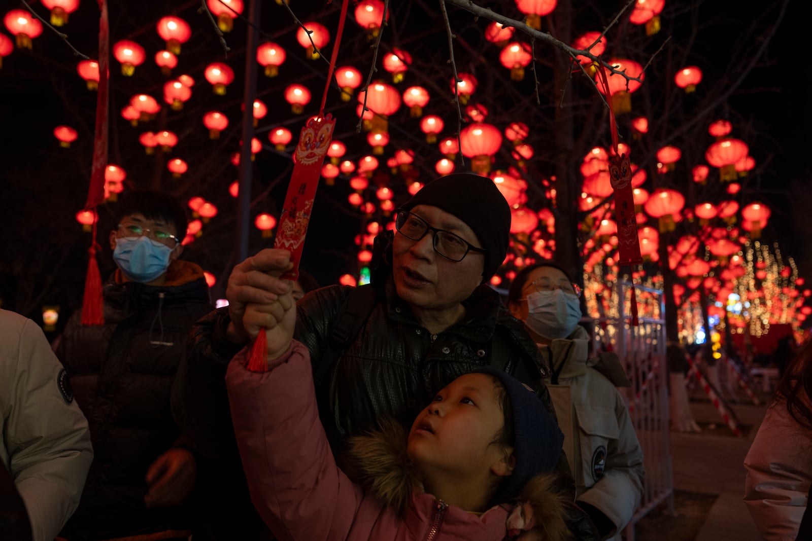 A child tries to guess lantern riddles, a tradition activity at the Lantern Festival during Yuanxiao, the fifteen day of the Lunar New Year in Beijing, Wednesday, Feb. 12, 2025. (AP Photo/Ng Han Guan)