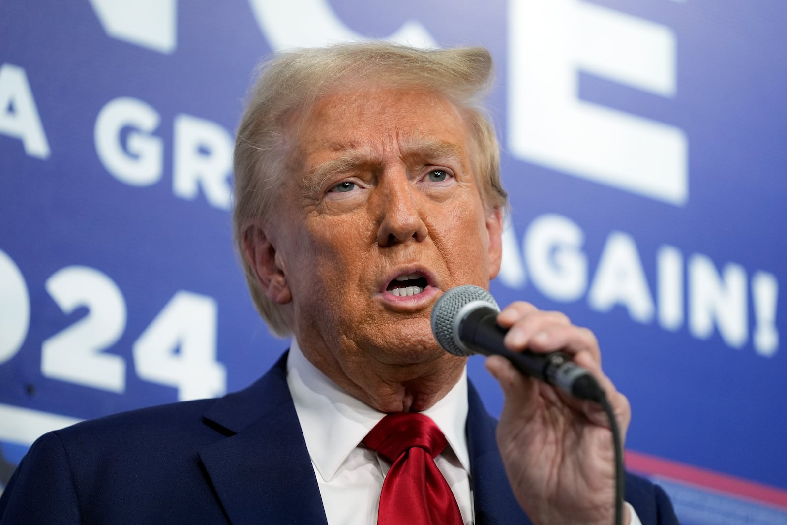 Republican presidential nominee former President Donald Trump speaks as he visits a campaign office, Friday, Oct. 18, 2024, in Hamtranck, Mich. (AP Photo/Evan Vucci)