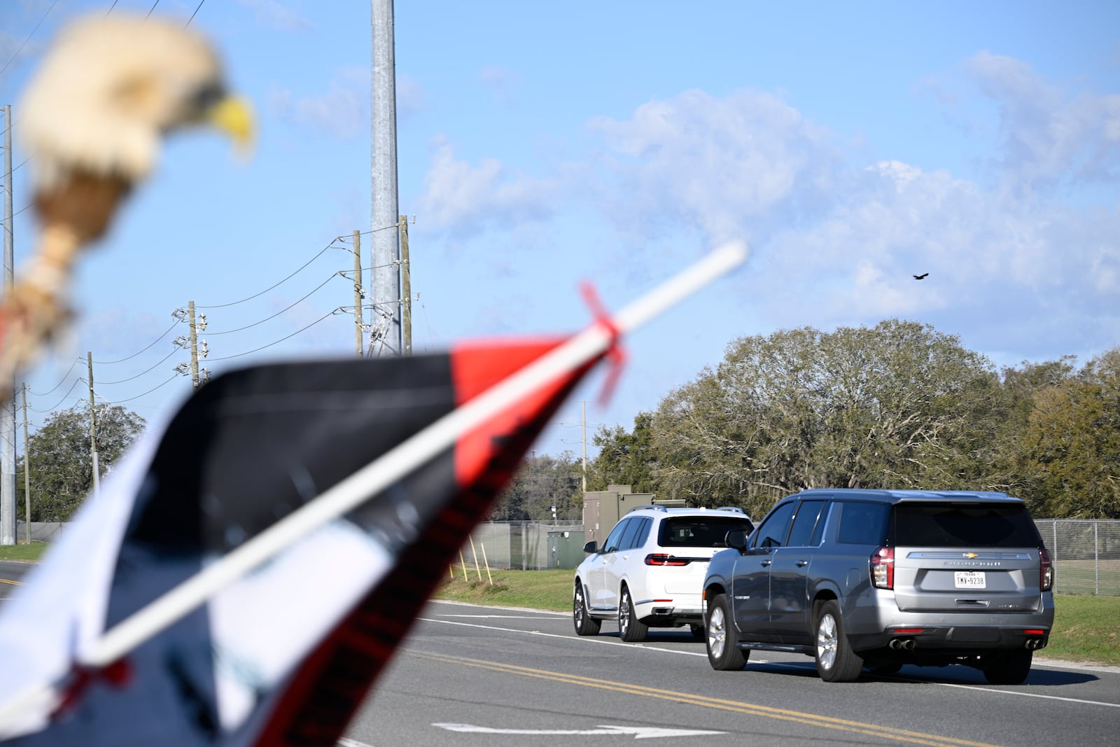 A vehicle carrying Leonard Peltier, right, leaves with an escort from the Federal Correctional Complex, Coleman, Tuesday, Feb. 18, 2025, in Sumterville, Fla. (AP Photo/Phelan M. Ebenhack)