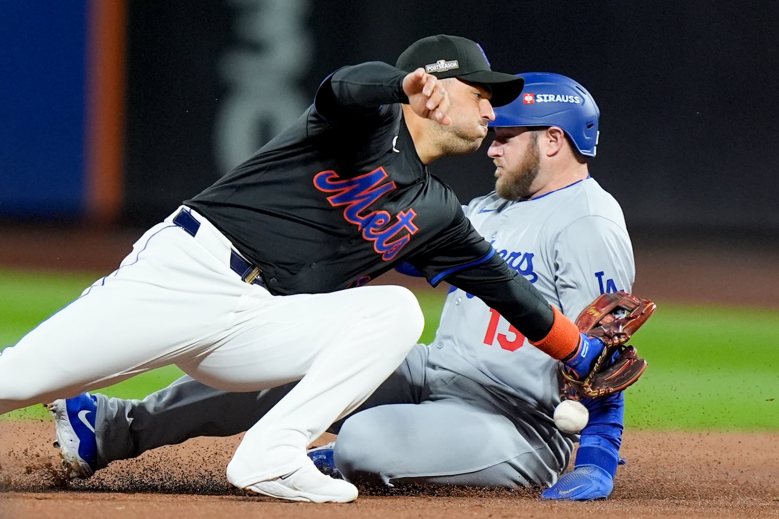 Los Angeles Dodgers' Max Muncy is safe past New York Mets second baseman Jose Iglesias during the second inning in Game 3 of a baseball NL Championship Series, Wednesday, Oct. 16, 2024, in New York. (AP Photo/Frank Franklin II)